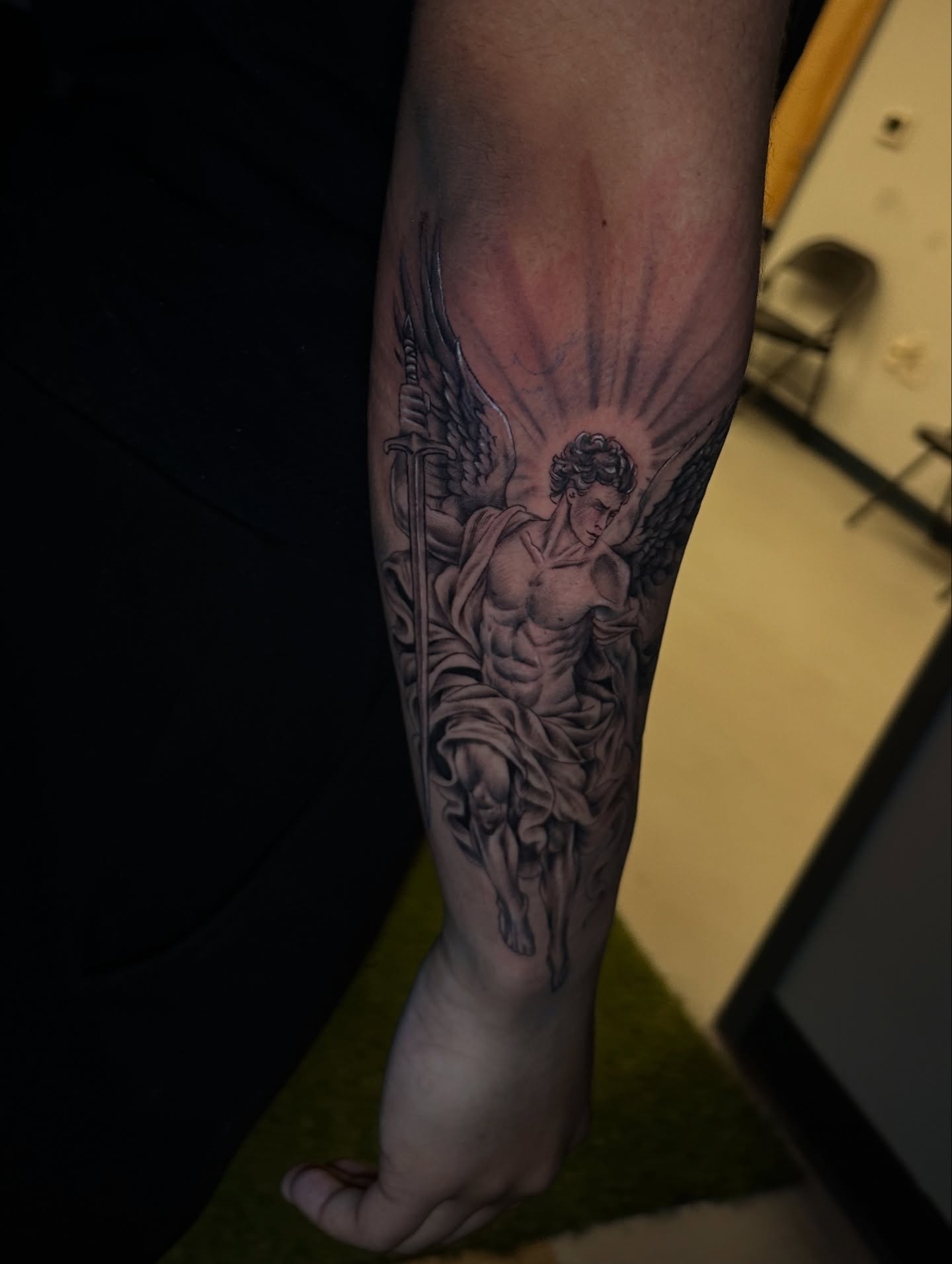 Angel with sword black and grey tattoo on the forearm by Chris (Pikasso)