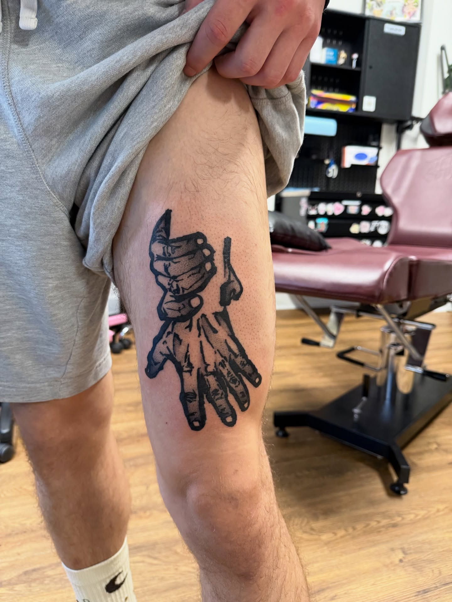 Mask and hand black and grey tattoo on the thigh by z o y a, Seattle, Washington