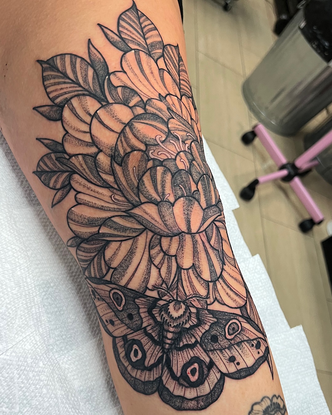 Flower moth dotwork tattoo on the forearm by @shannonkeeleyy