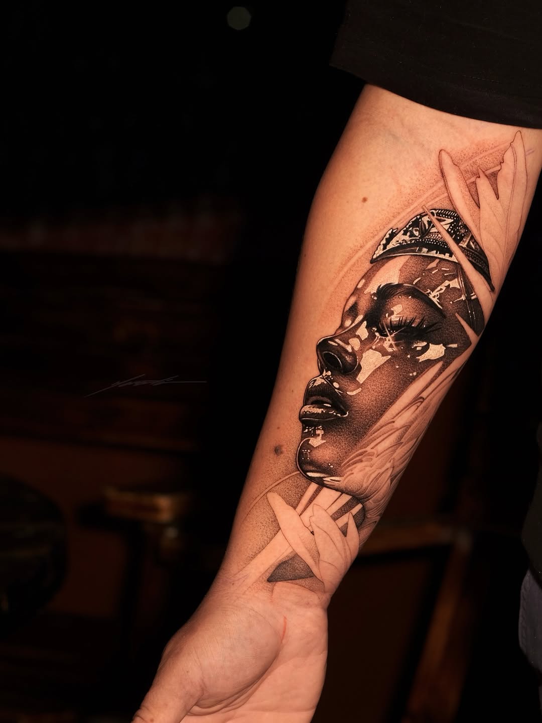 Portrait of a woman with feathers realism tattoo on the forearm by Ke$la