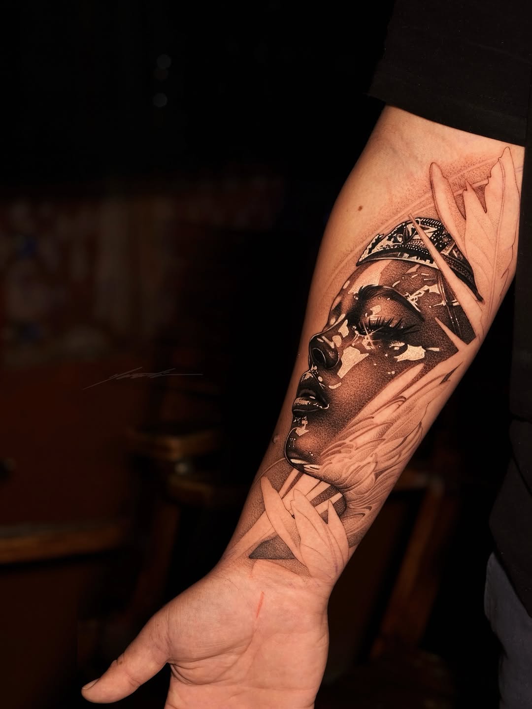 Portrait of a woman with feathers realism tattoo on the forearm by Ke$la