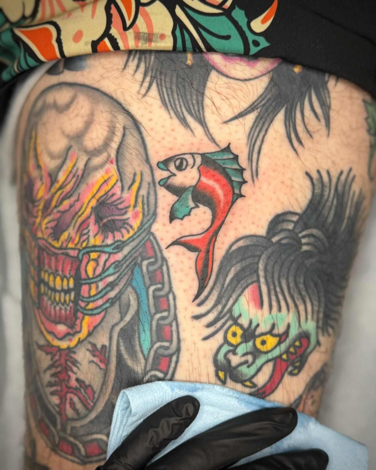 Skull and fish American traditional tattoo on the thigh by kalli berry