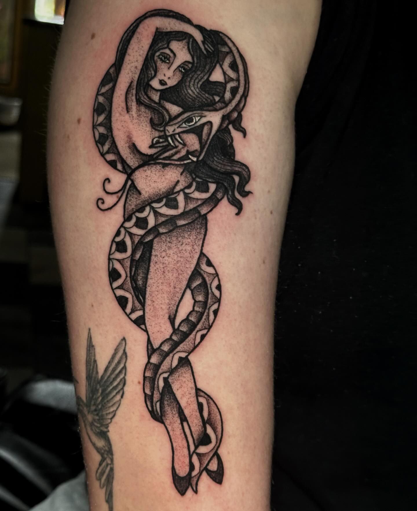 Woman with snake dotwork tattoo on the forearm by Elizabeth Tabler