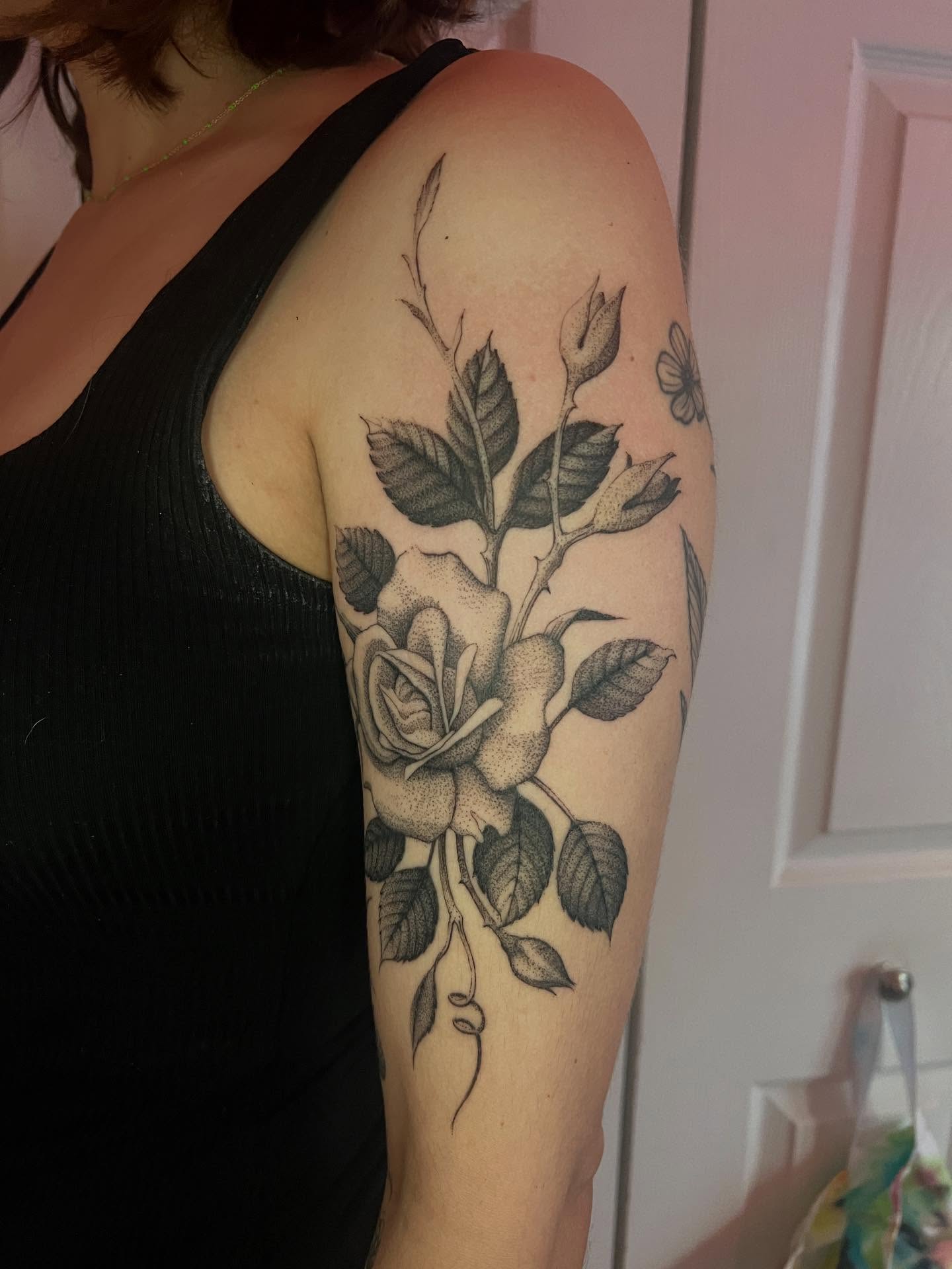 Rose dotwork tattoo on the upper arm by Natasha