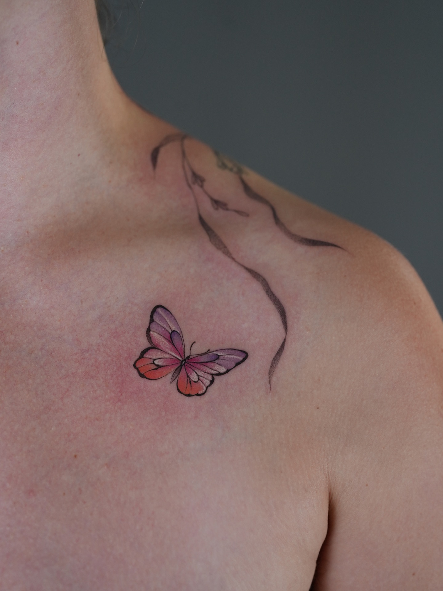 Butterfly watercolor tattoo on the chest by X