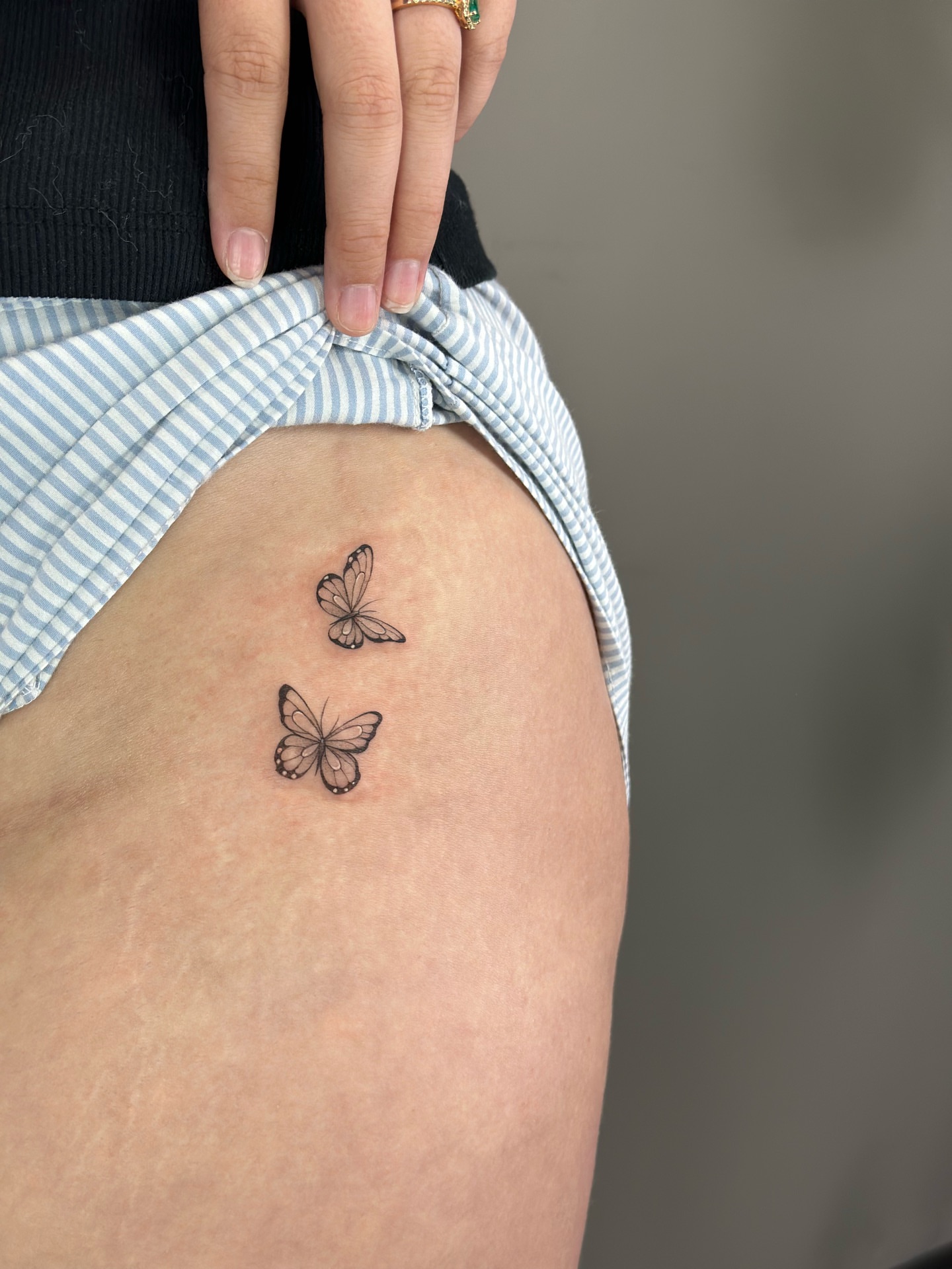 Butterflies black and grey tattoo on the thigh by X
