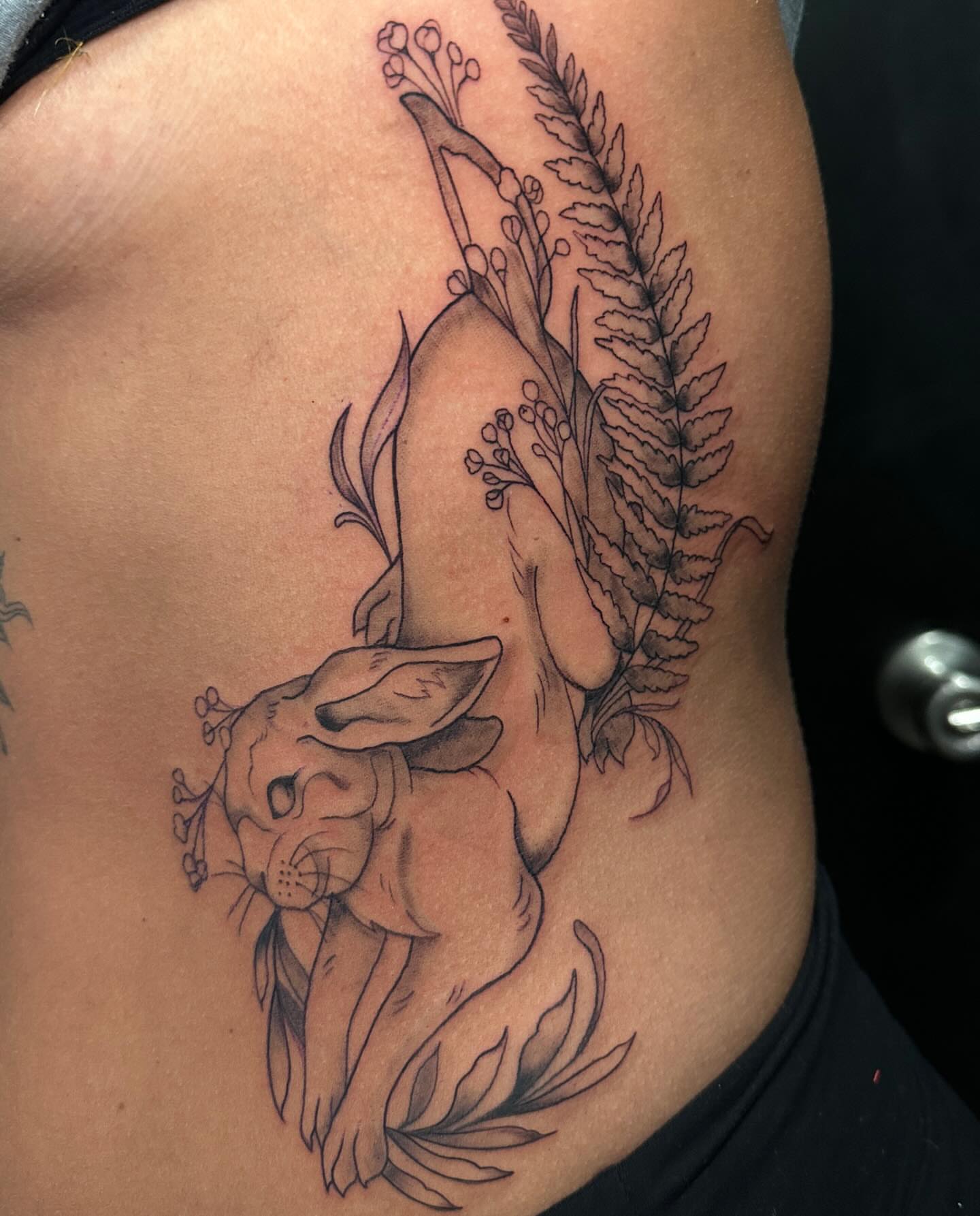 Deer and fern black and grey tattoo on the ribs by Mika'la Berry