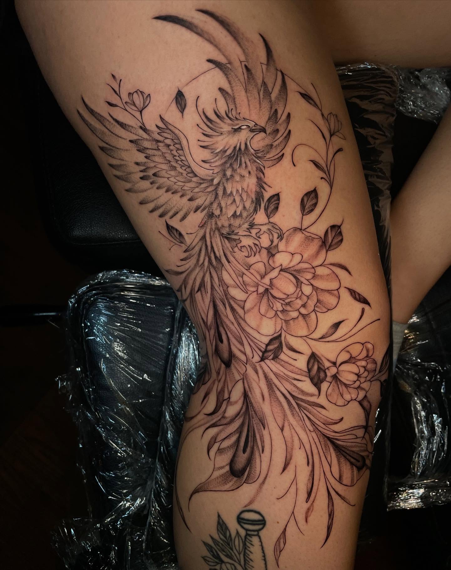Phoenix and flowers realism tattoo on the thigh by Lauren Sisouphanh, Canton, Ohio