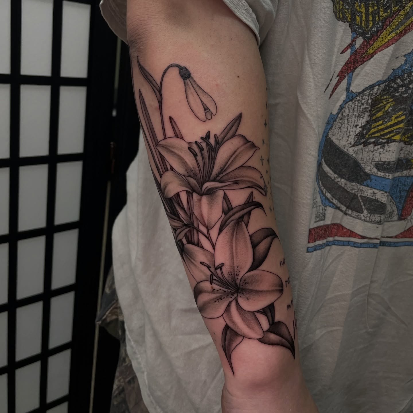 Lilies black and grey tattoo on the forearm by kaylee
