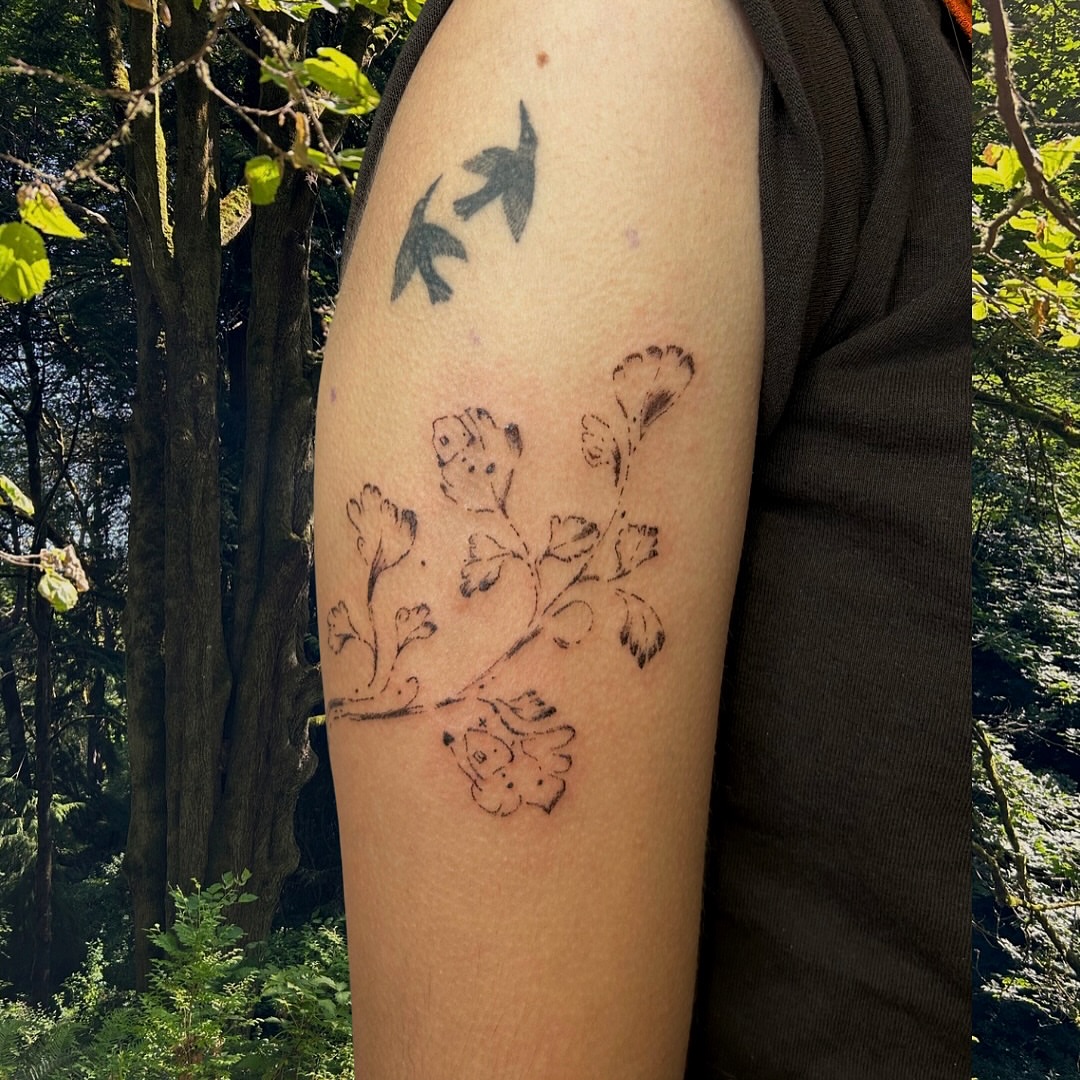 Flower branch black and grey tattoo on the forearm by wanderfernfairy