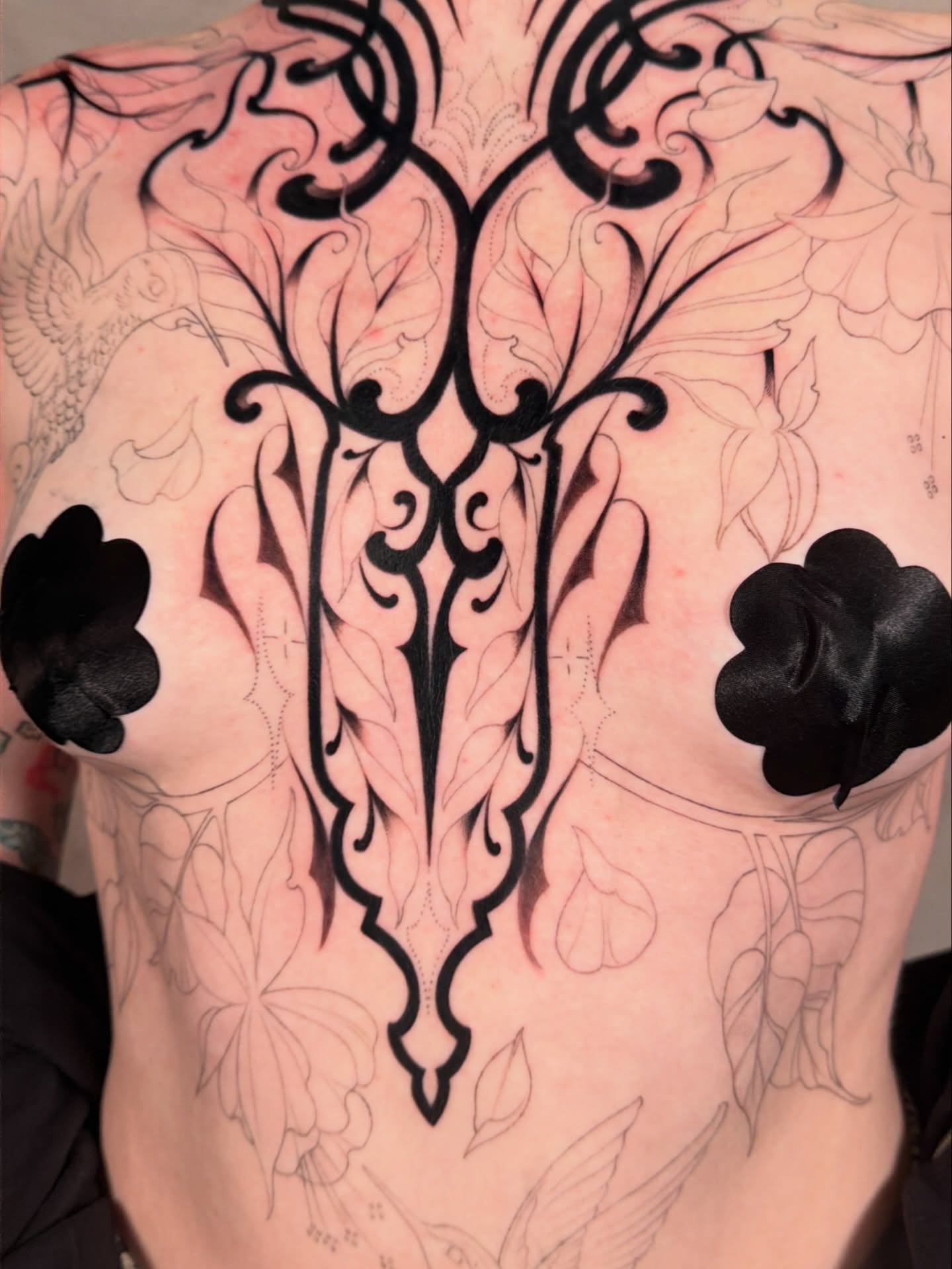 Floral pattern tribal tattoo on the chest by <