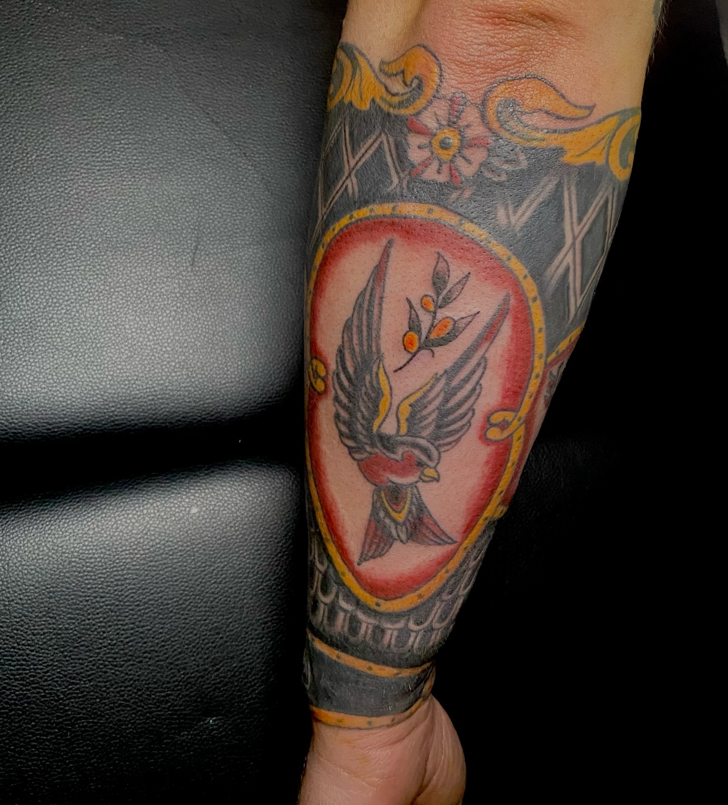 Bird with olive branch American traditional tattoo on the forearm by Giuseppe T.C.