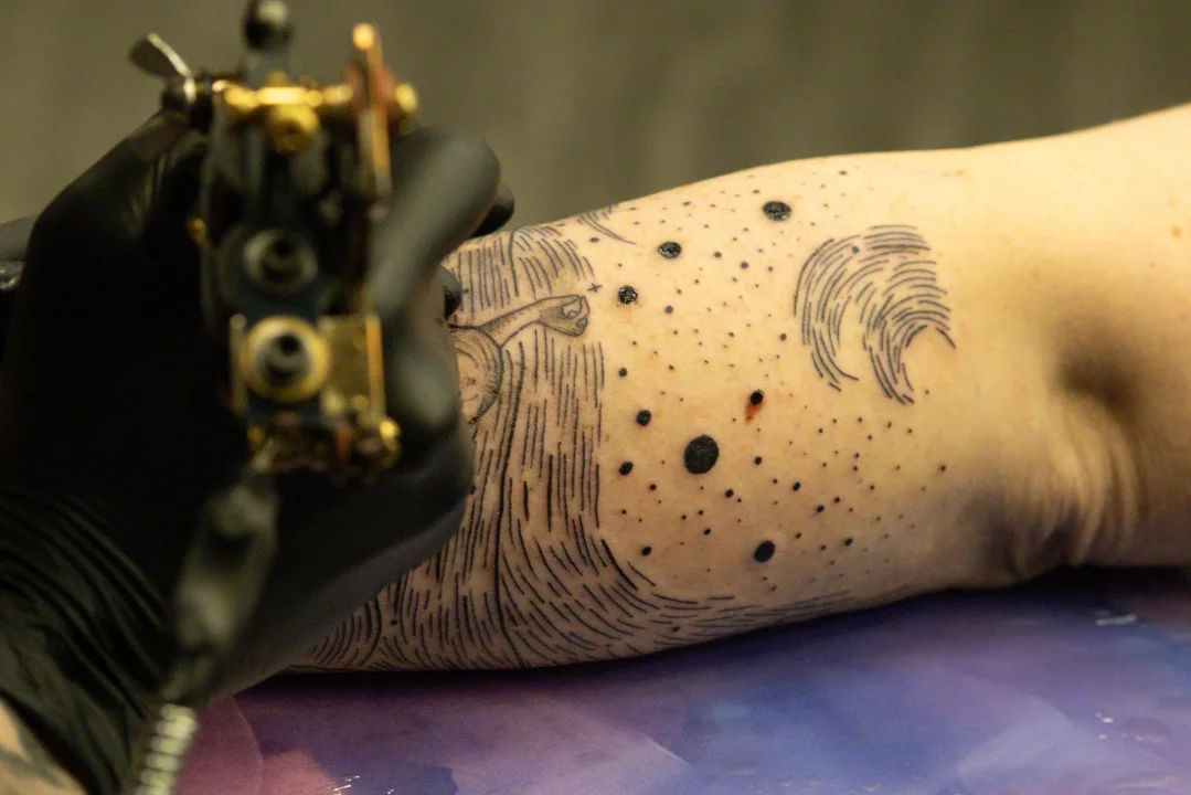 Space-themed design dotwork tattoo on the forearm by Linda Marroum, Morningside, Maryland