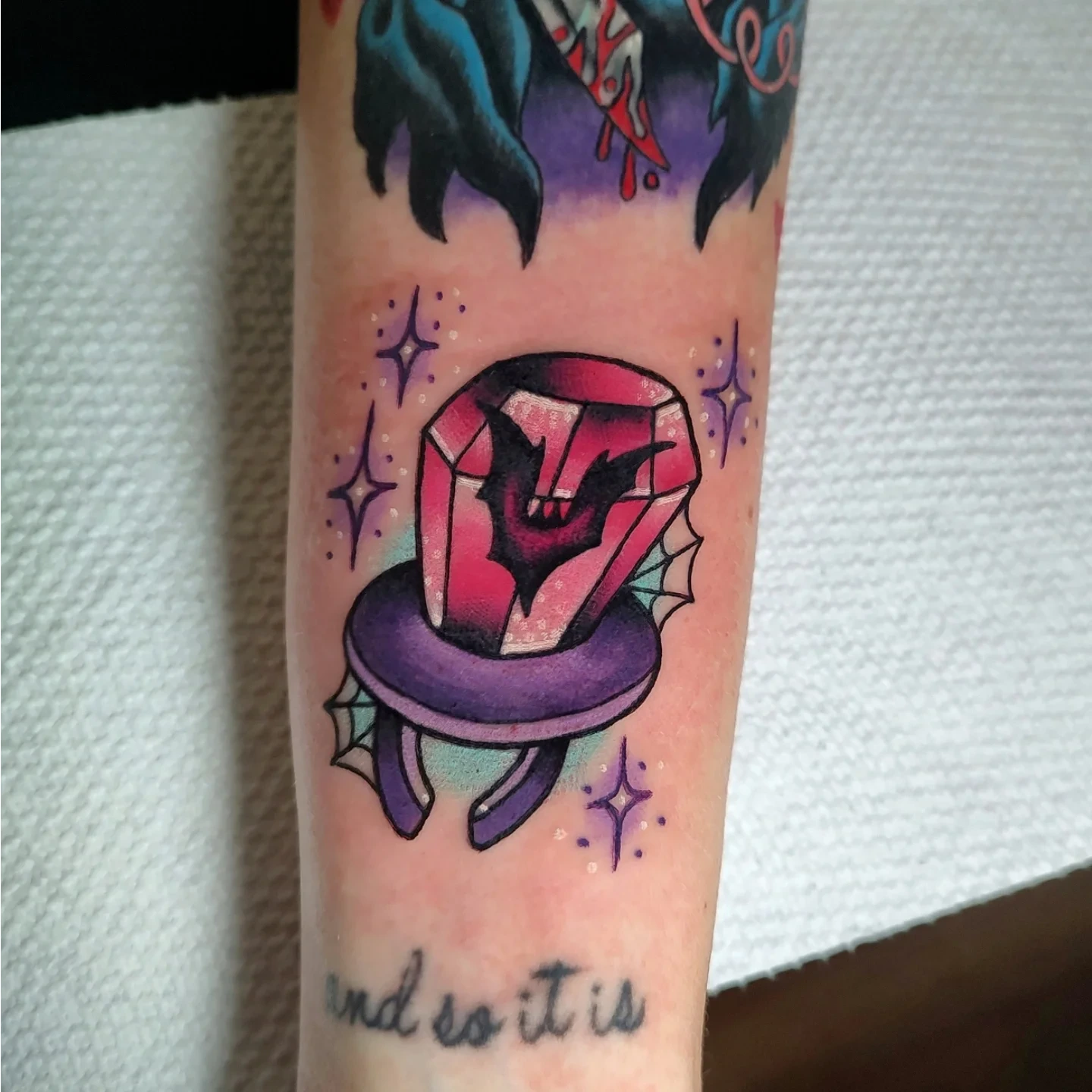 Gemstone and snake American traditional tattoo on the forearm by Hope Higgins