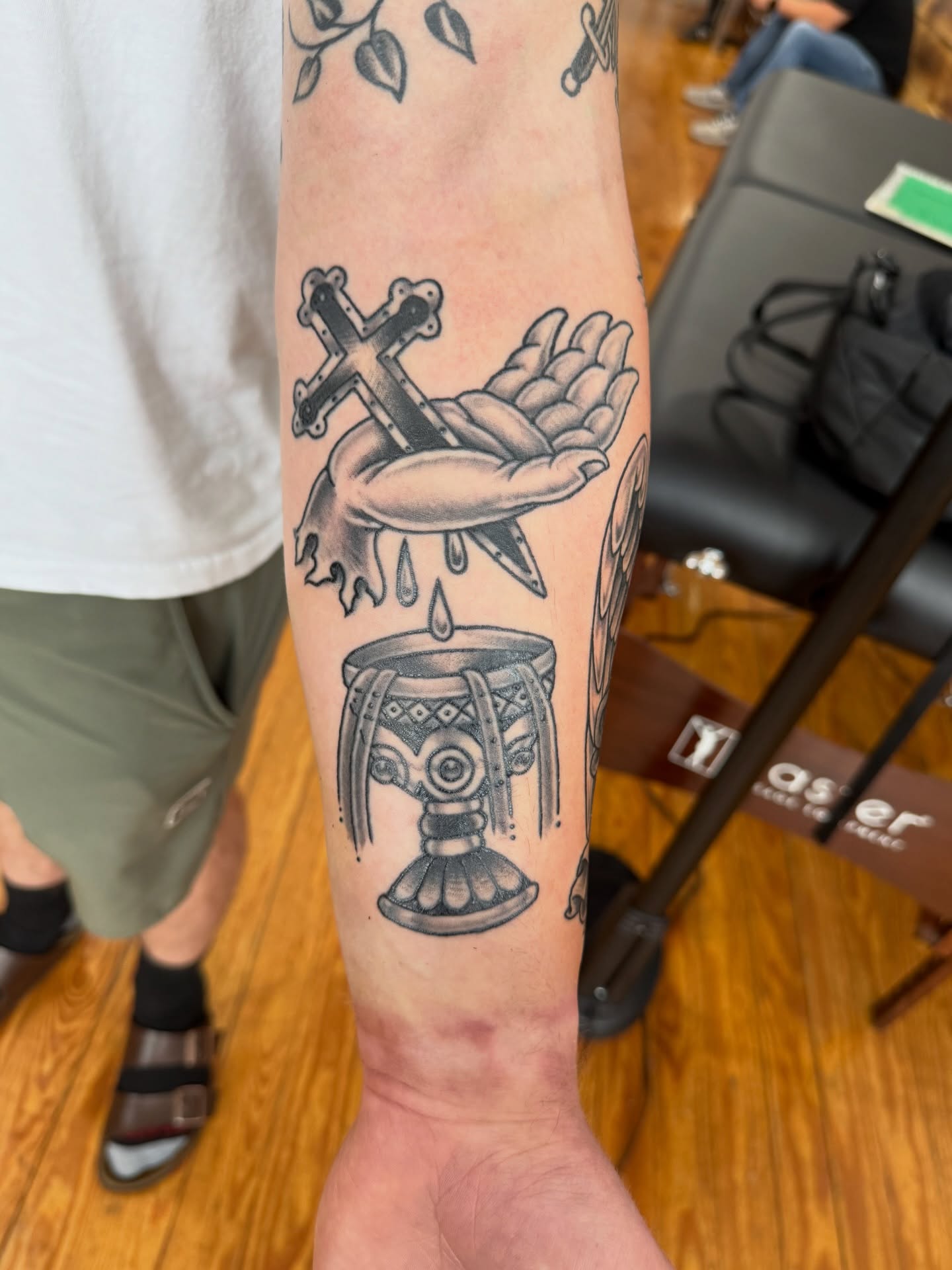 Religious symbols black and grey tattoo on the forearm by Zak Colburn