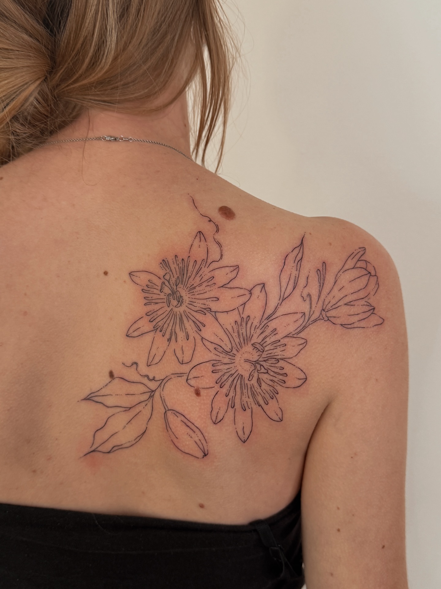 Passion flowers black and grey tattoo on the shoulder by Inky Apricot, Austin, Texas