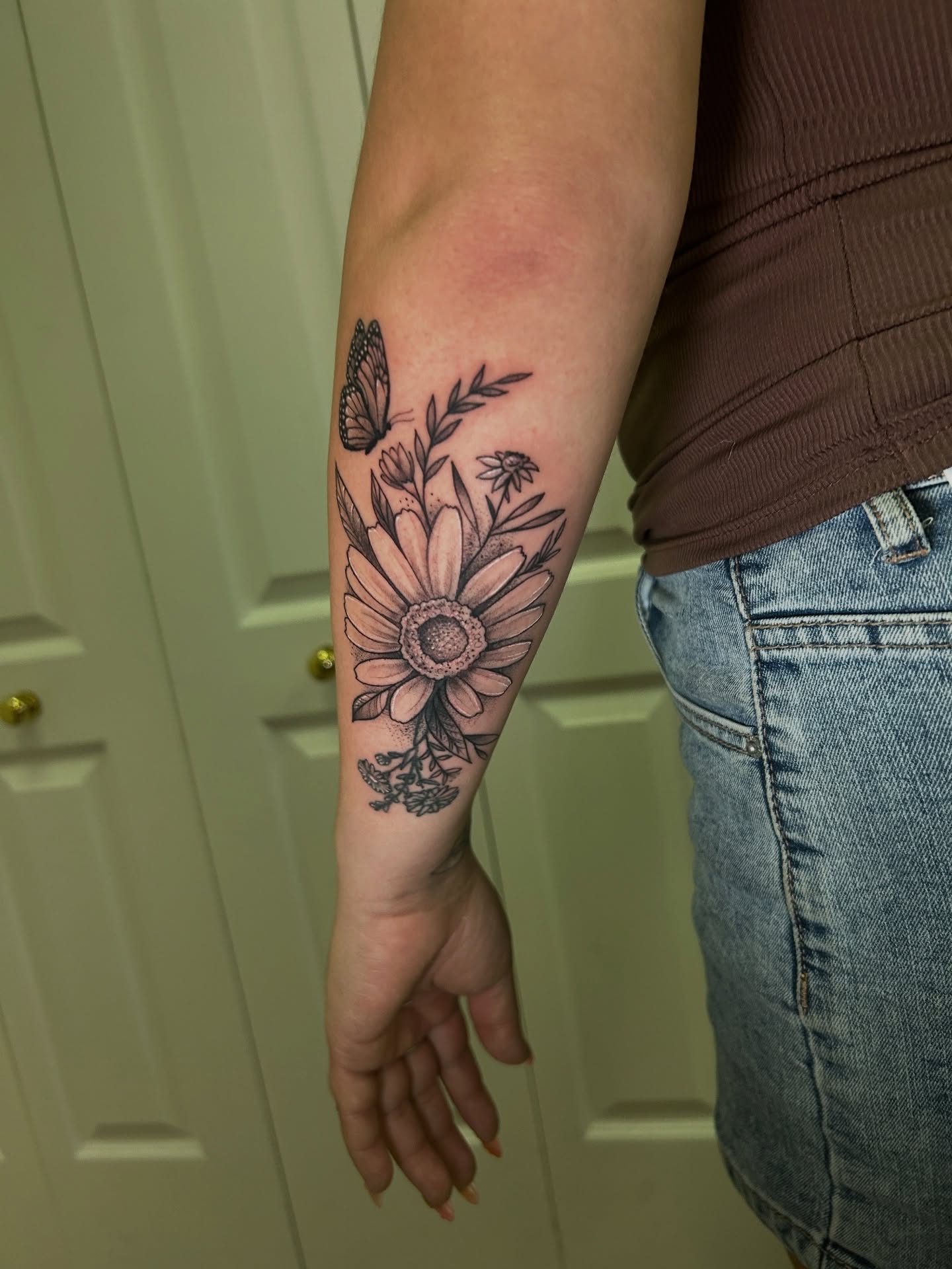 Sunflower bouquet realism tattoo on the forearm by Mando Castro