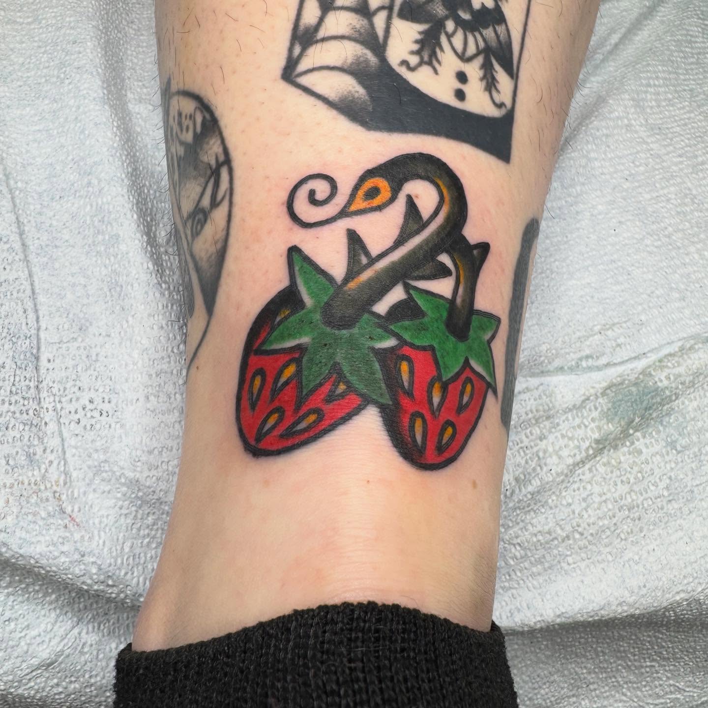 Strawberries American traditional tattoo on the forearm by JoJo Benton