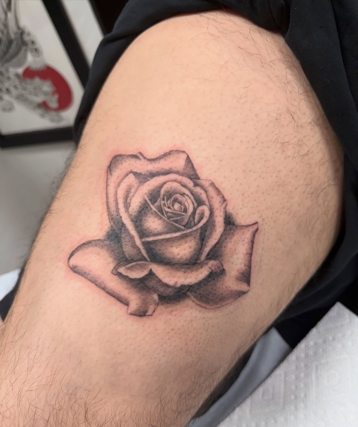 Rose black and grey tattoo on the thigh by Kayla Jackson, Phoenix, Arizona
