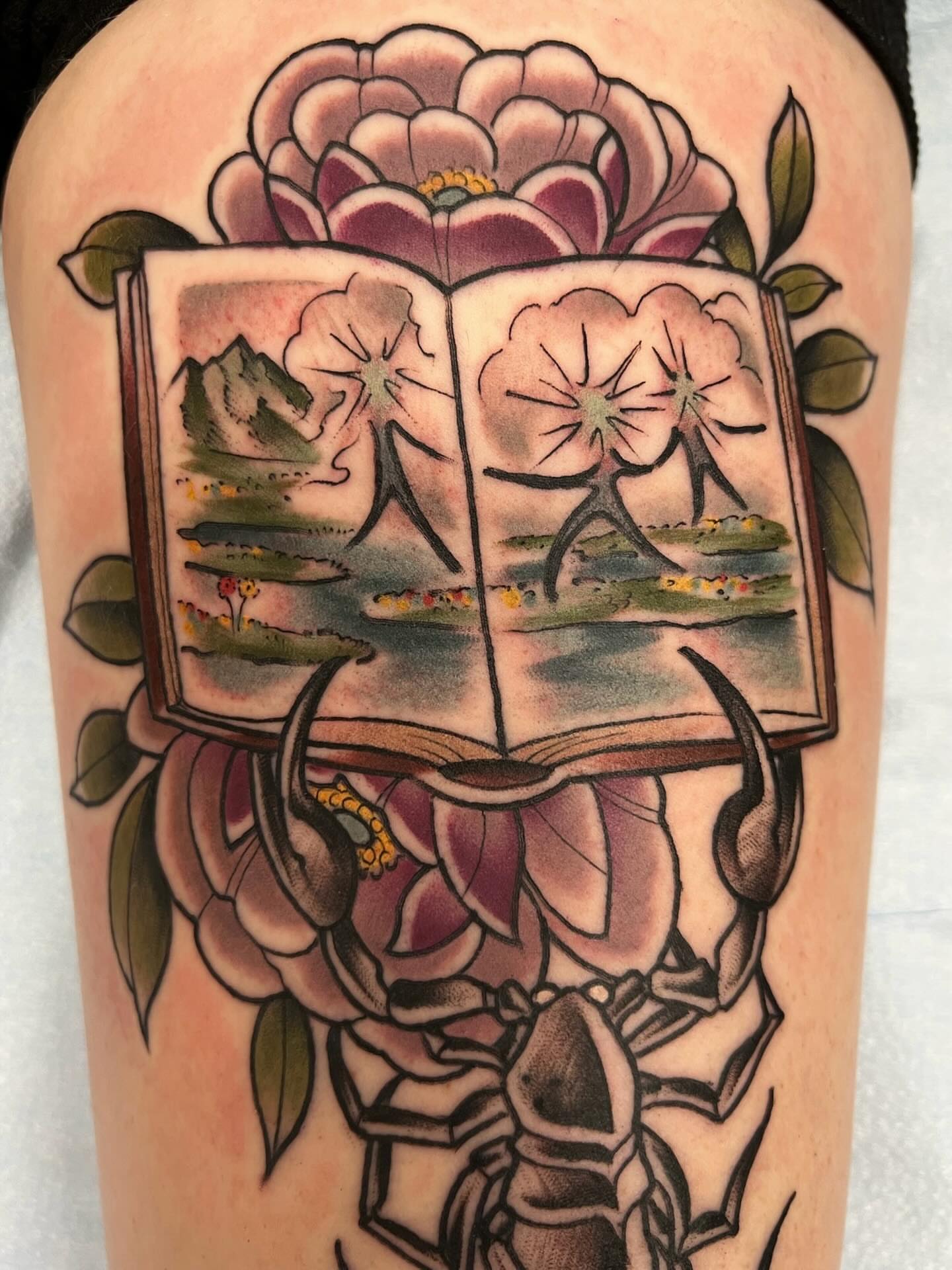 Book with floral illustrations American traditional tattoo on the forearm by Kyle Olson, Salt Lake City, Utah