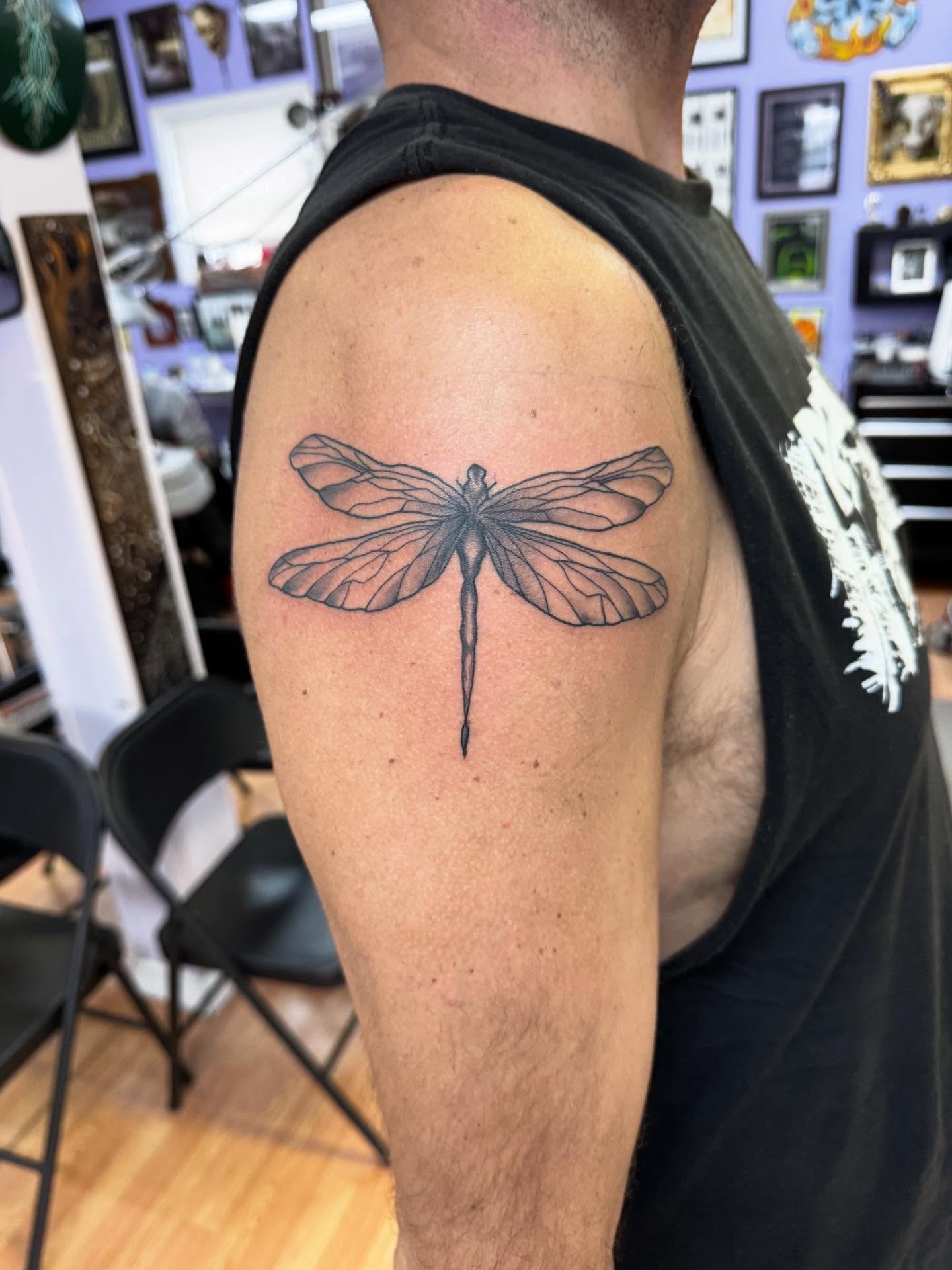 Dragonfly black and grey tattoo on the shoulder by Justin Fiveson