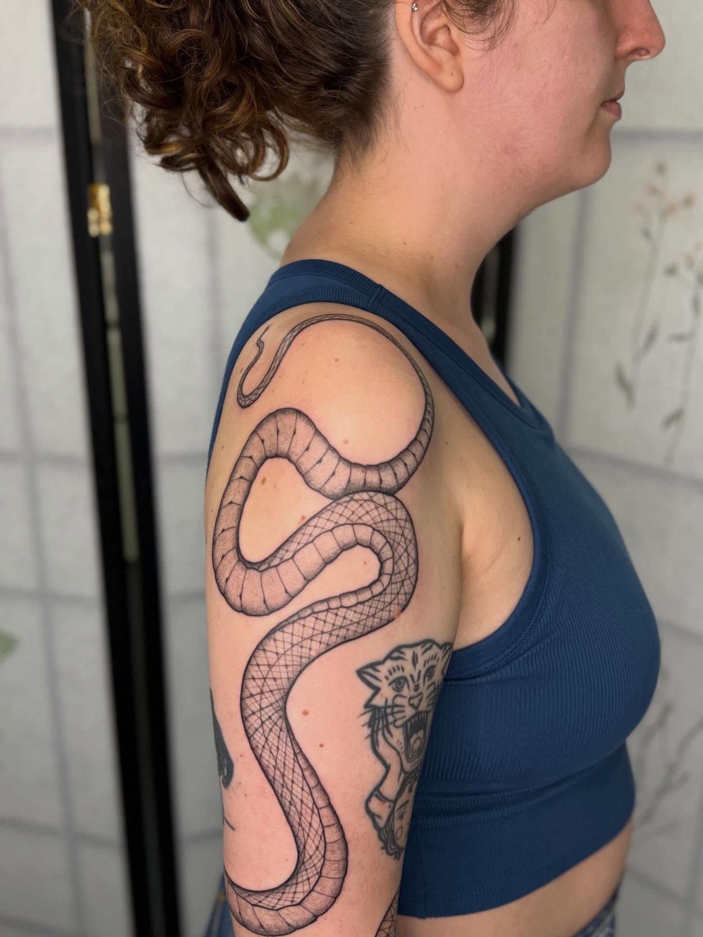 Snake black and grey tattoo on the shoulder by Noelle Adrienne Tattoos