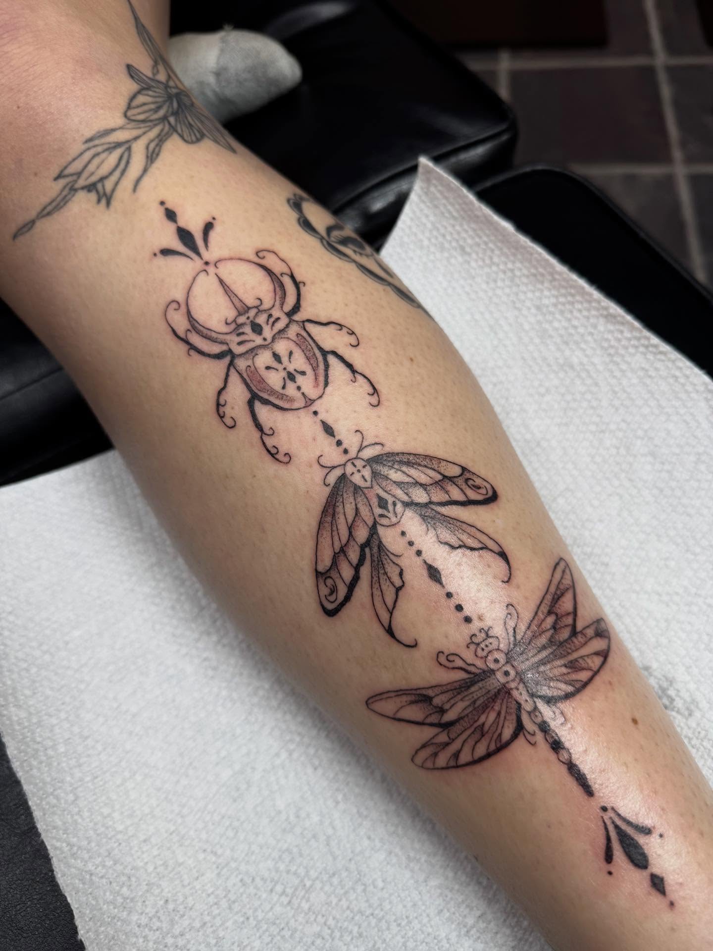 Insects black and grey tattoo on the forearm by olivia reed