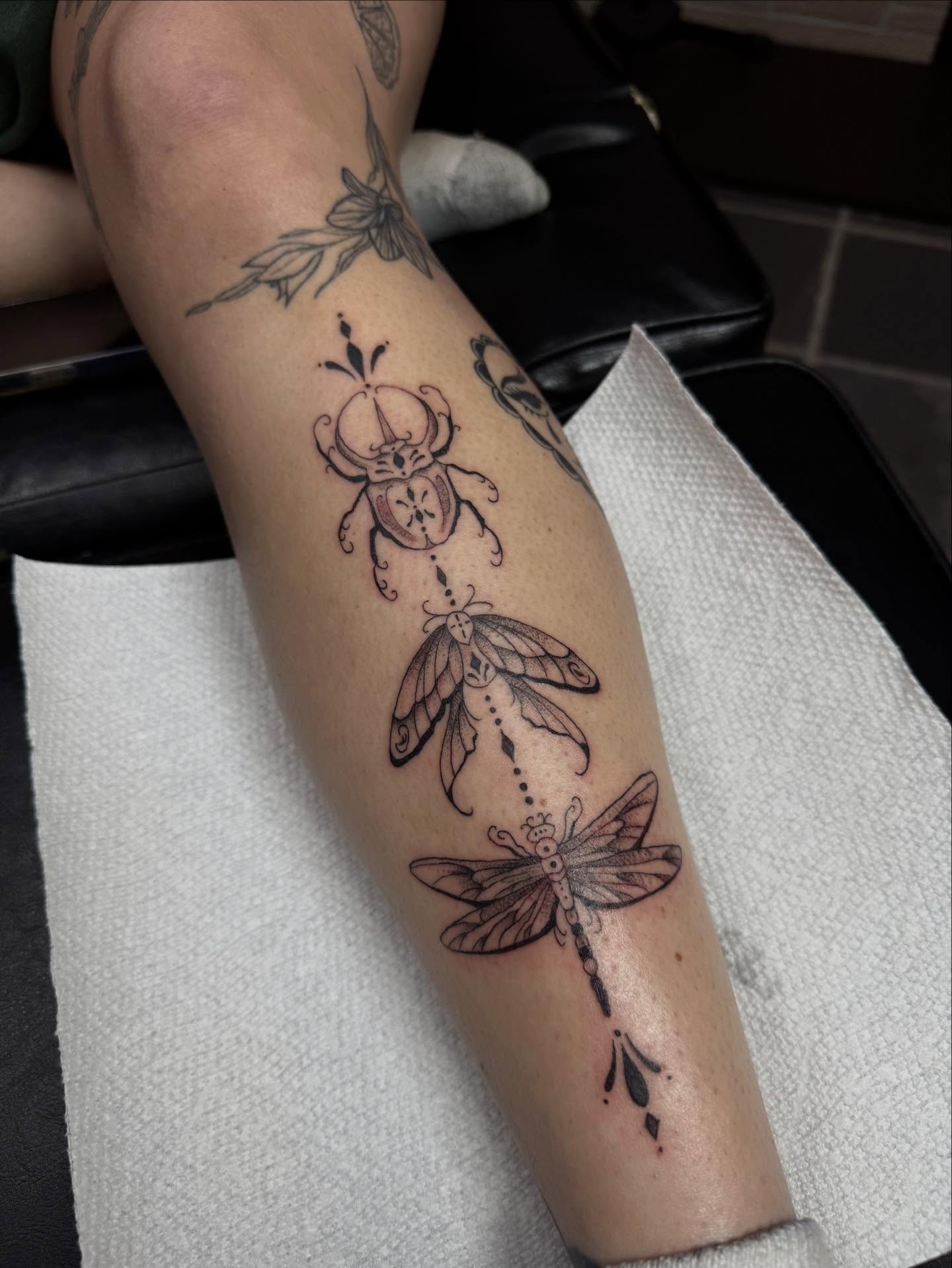 Insects black and grey tattoo on the forearm by olivia reed