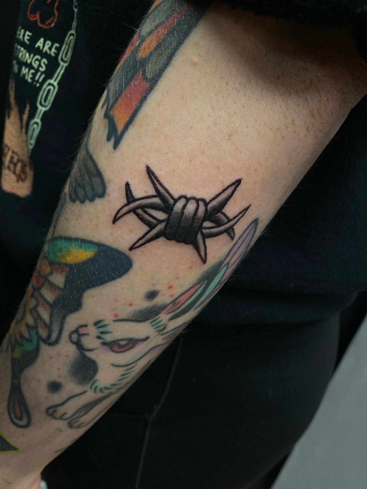 Barbed wire American traditional tattoo on the forearm by Corinne Carter