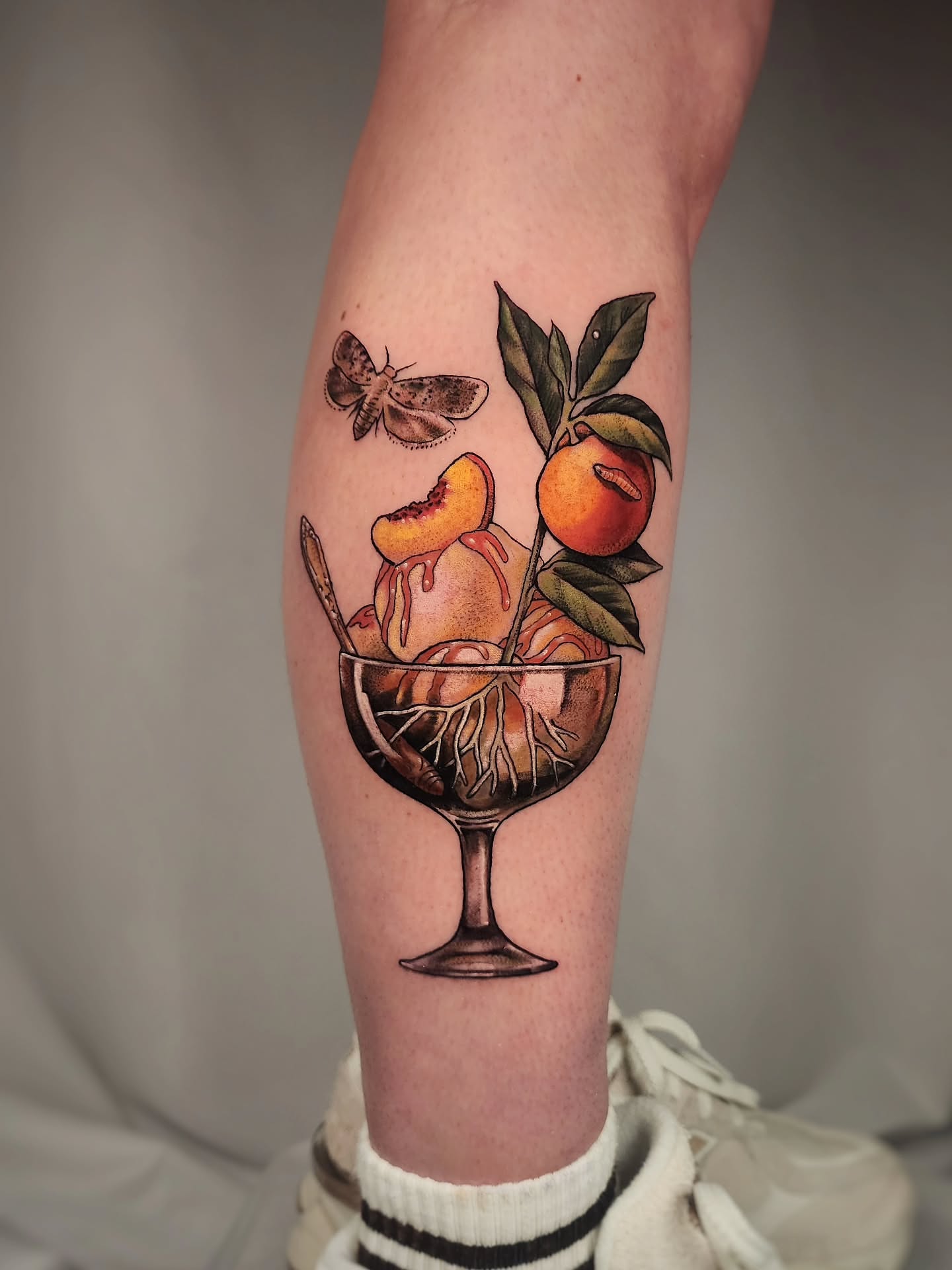 Fruit cocktail realism tattoo on the forearm by Whitney Caskey