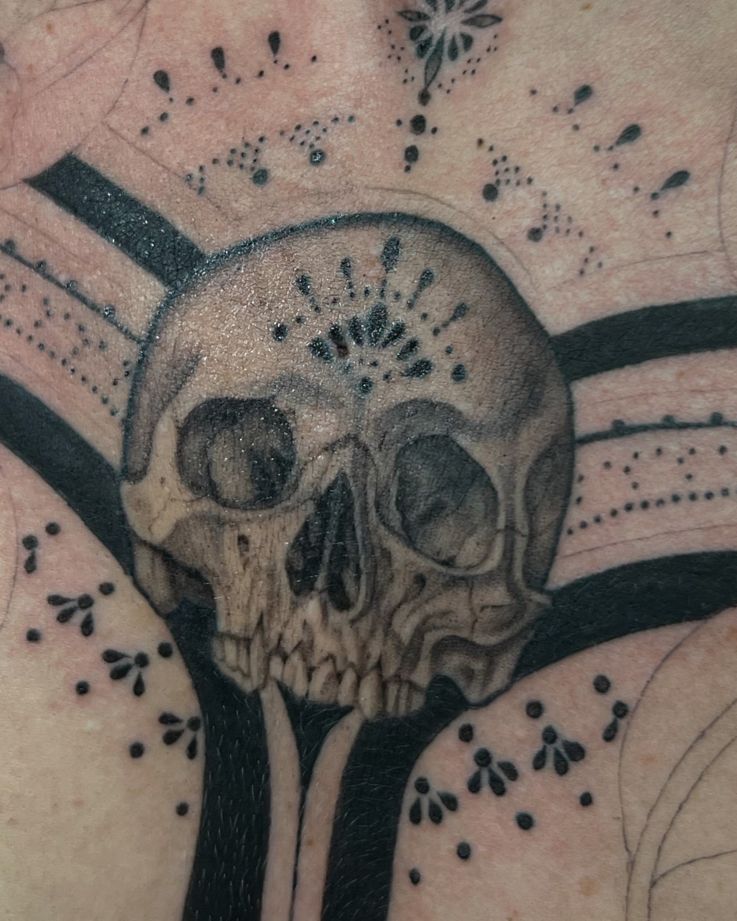 Skull dotwork tattoo on the forearm by Jordyn Tinney