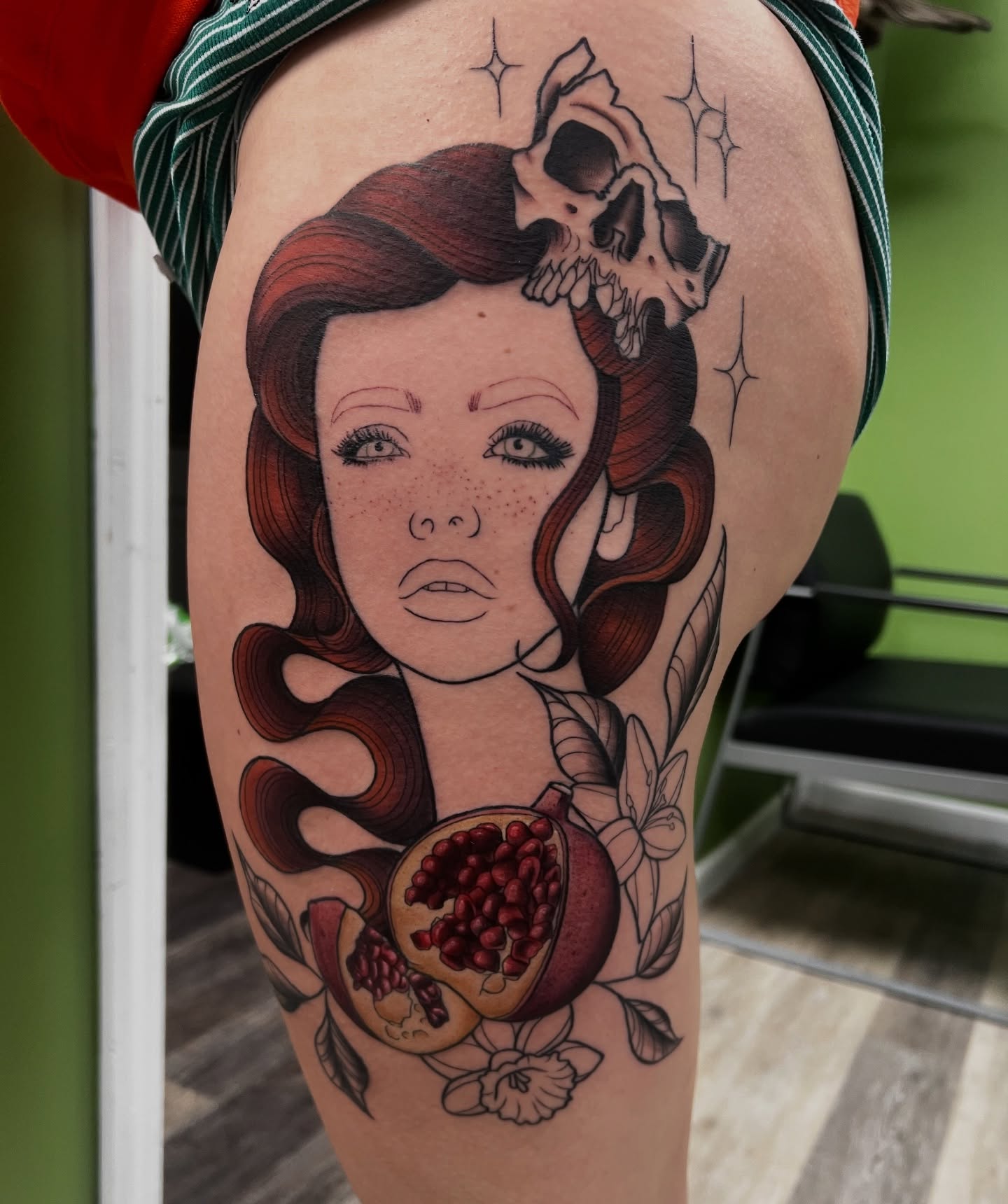 Woman with pomegranate realism tattoo on the thigh by Olivia Suzanne Fada