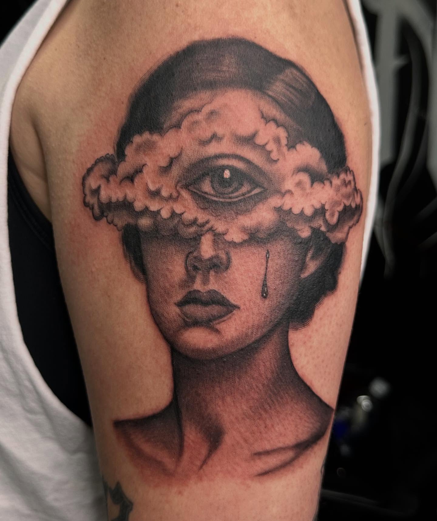 Woman's face with cloud realism tattoo on the forearm by Kimberly landin