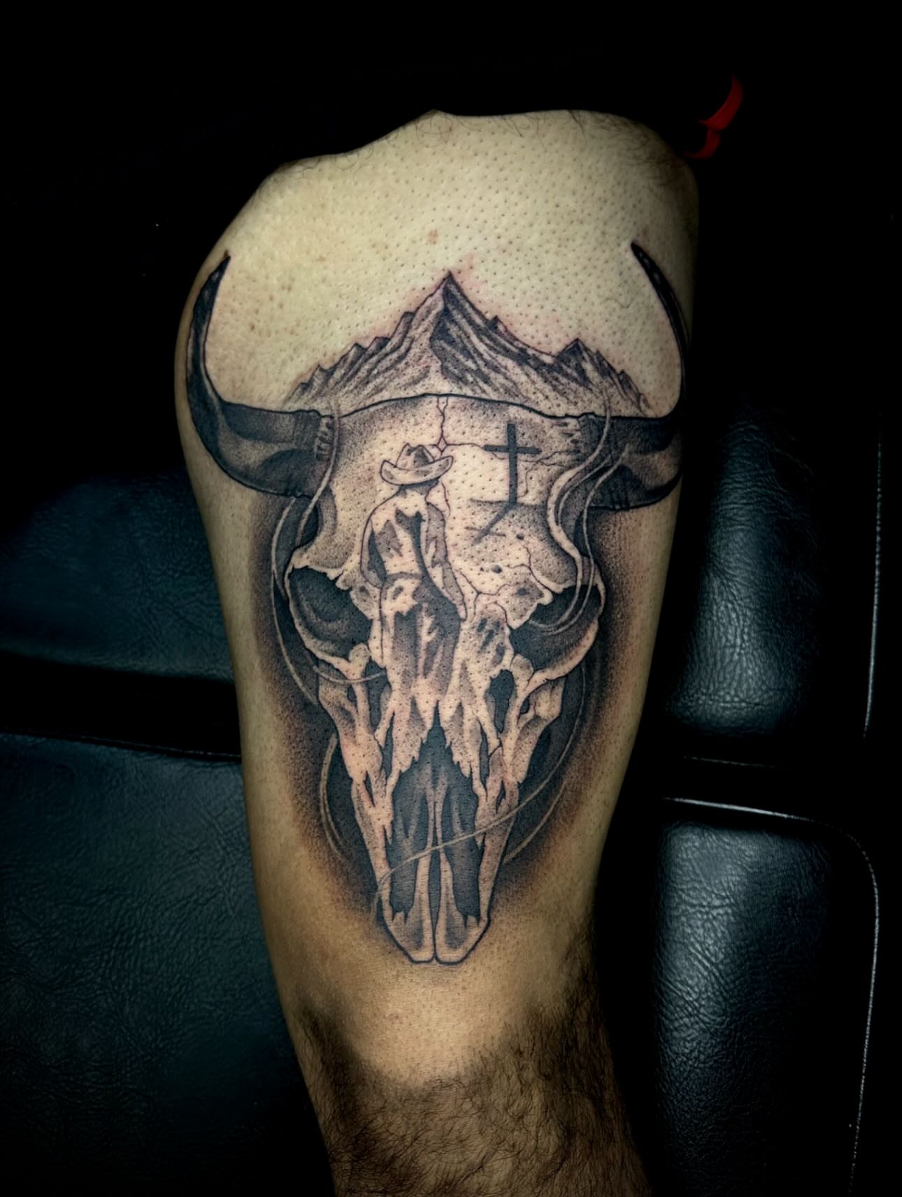 Cow skull with cowboy dotwork tattoo on the forearm by Madison Orchard Tattoos
