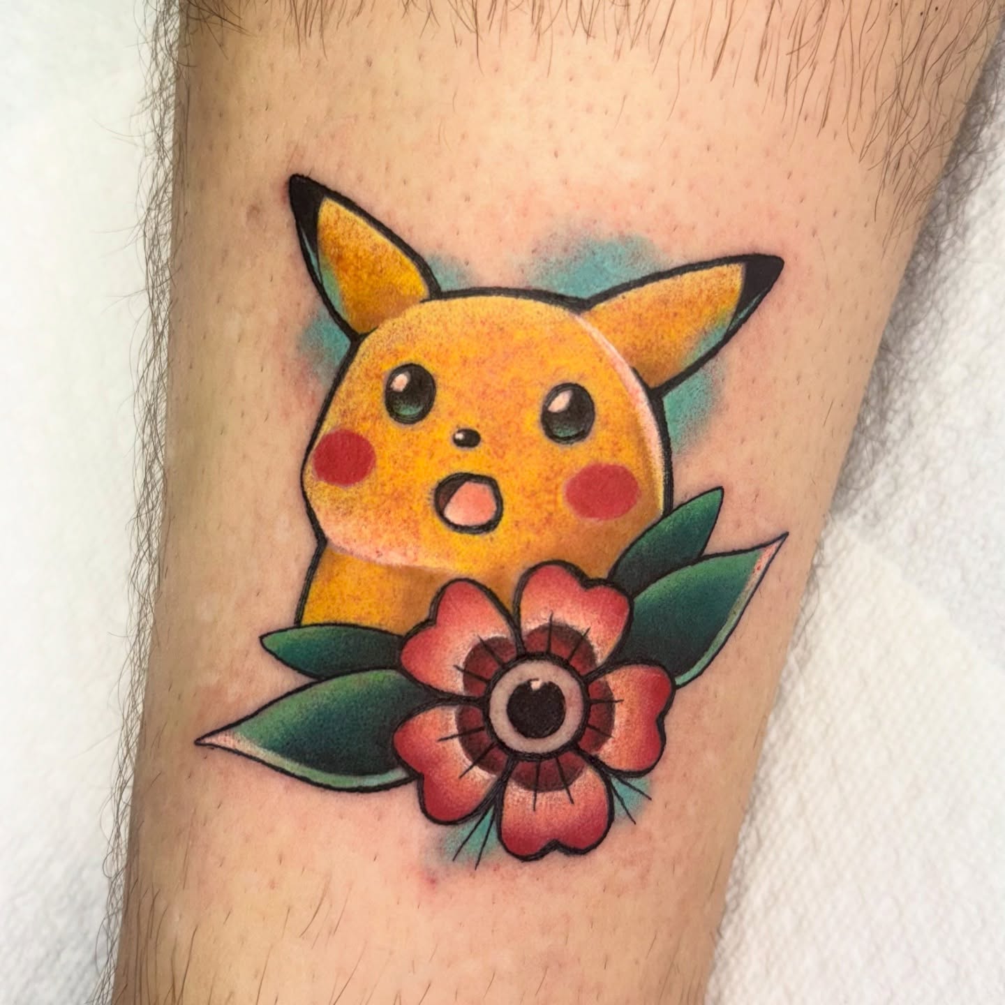 Pikachu with flower American traditional tattoo on the forearm by Lilac Rose