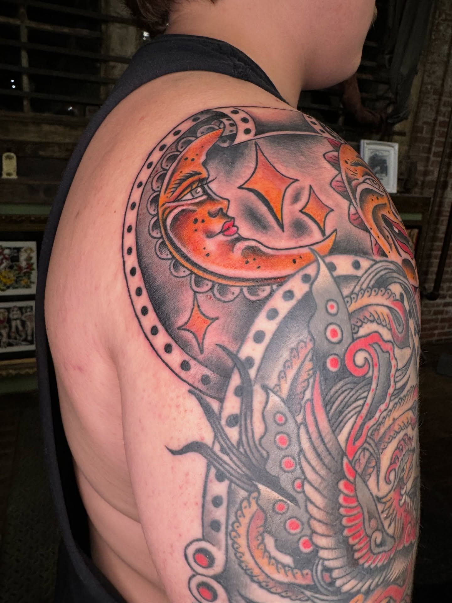 Moon and octopus American traditional tattoo on the shoulder by Marc Brotemarkle