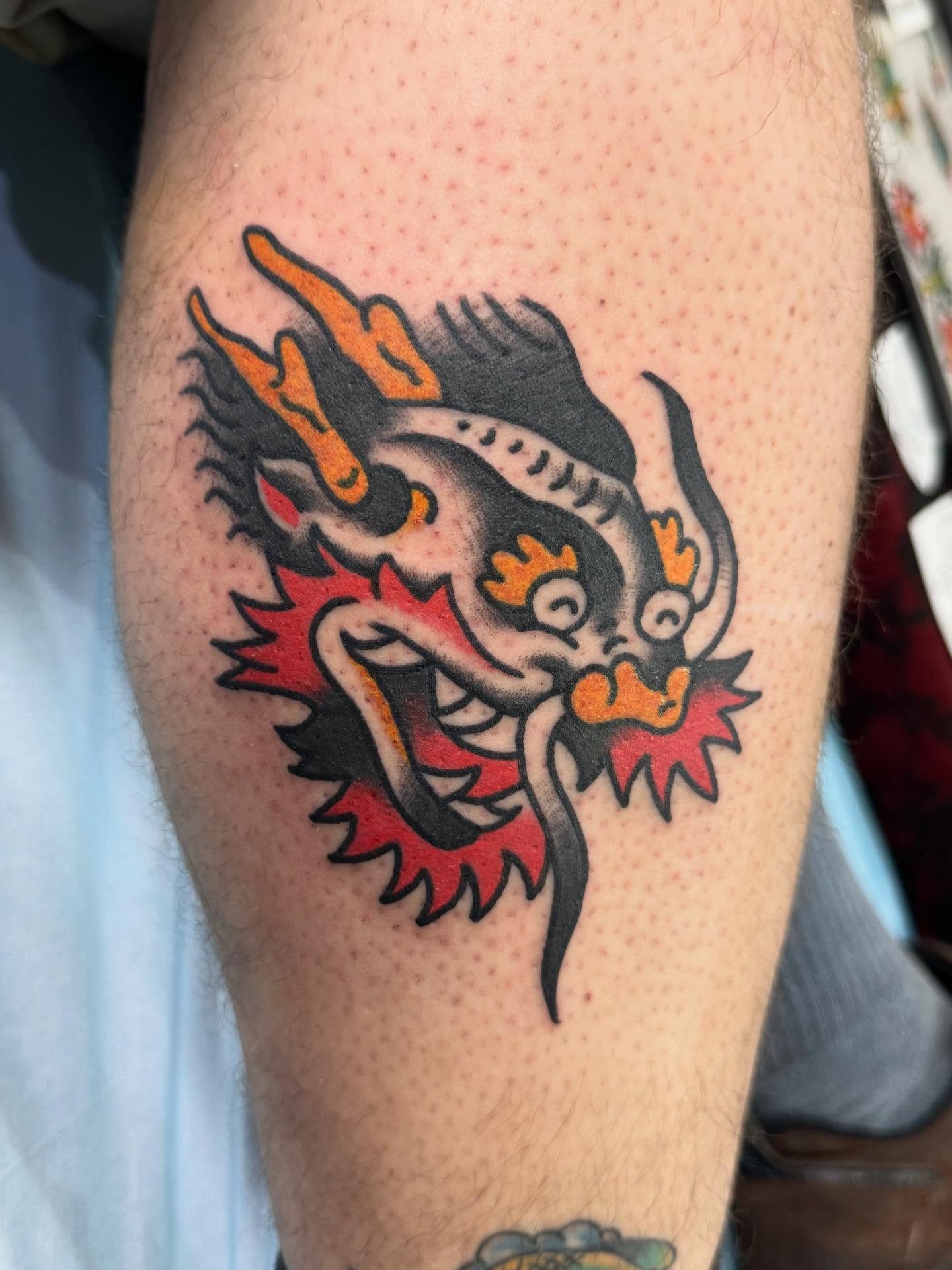 Dragon American traditional tattoo on the forearm by Jesse Coldiron