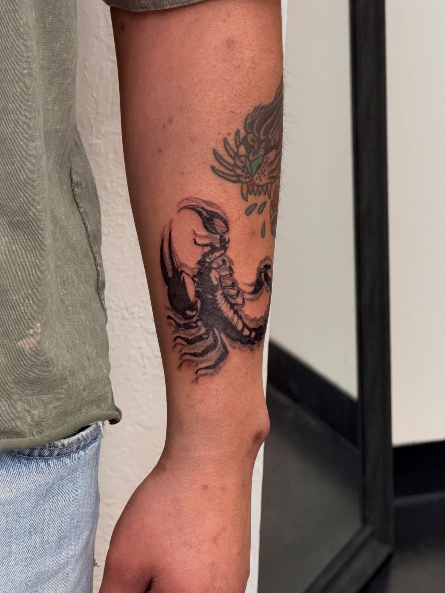 Scorpion black and grey tattoo on the forearm by Bryan Nguyen