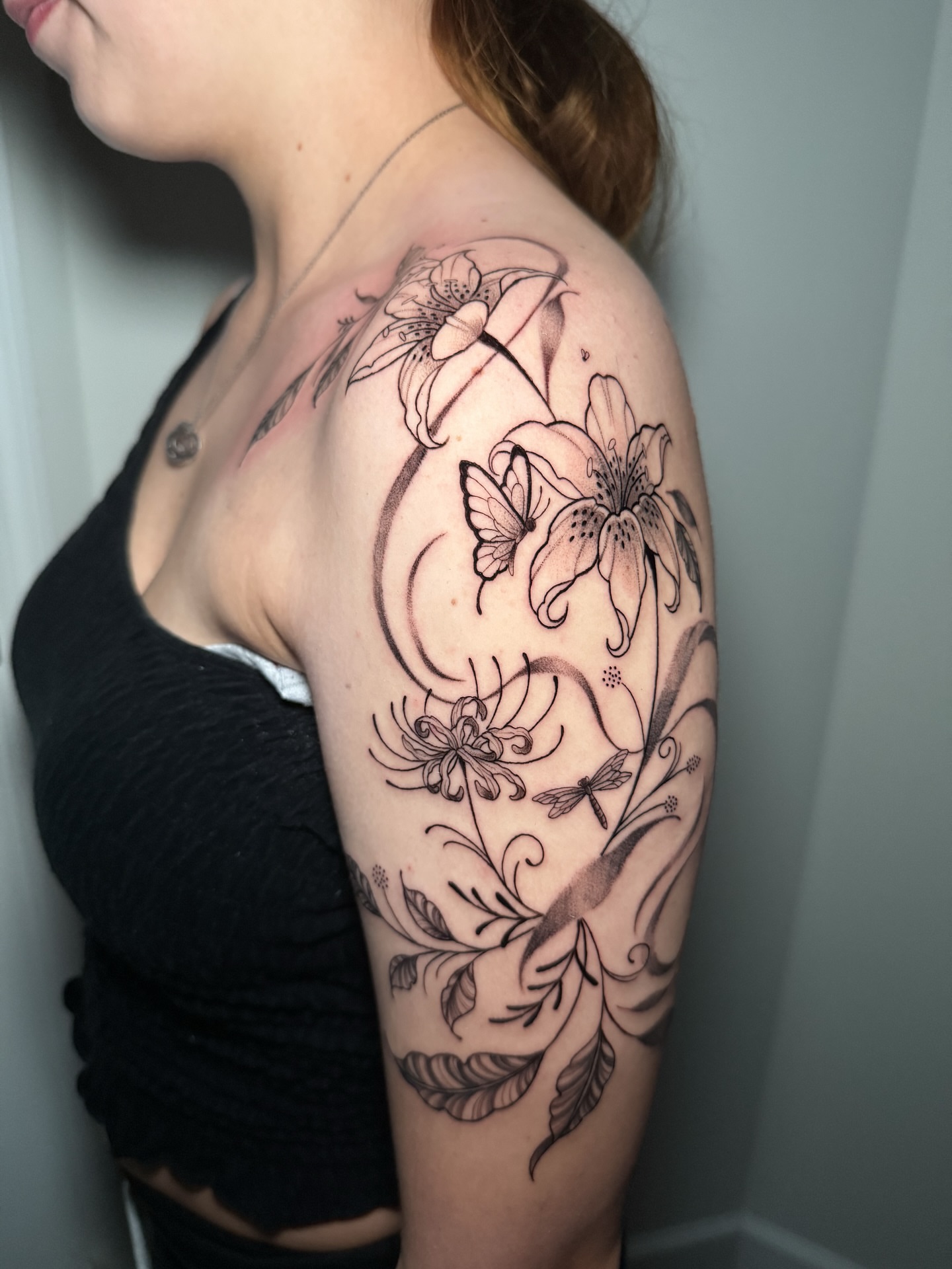 Floral and butterfly black and grey tattoo on the shoulder by 𝕹𝖆𝖙