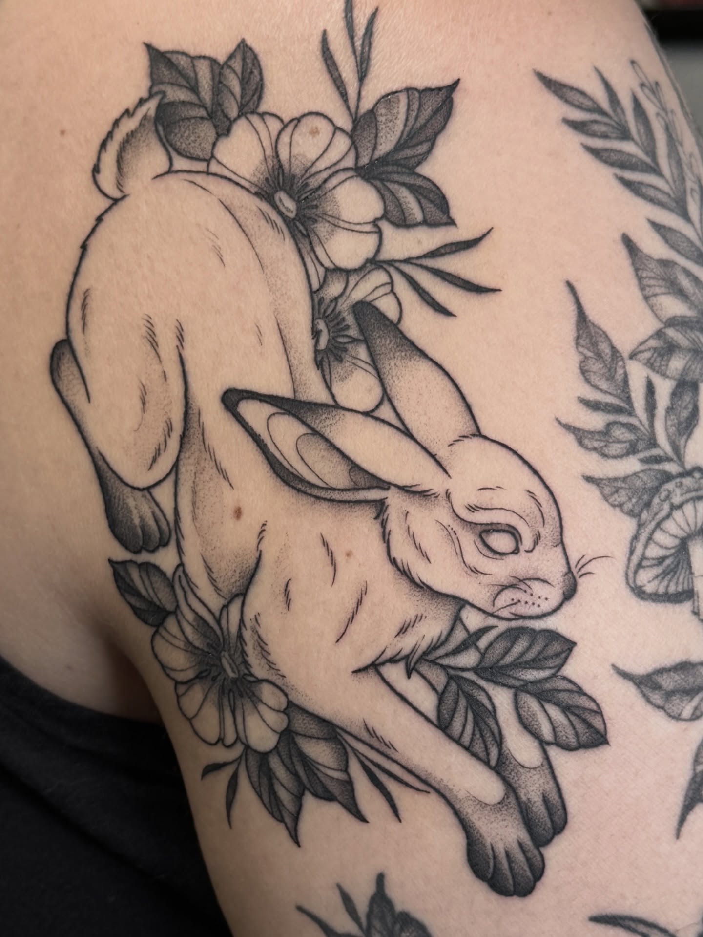 Rabbit and flowers black and grey tattoo on the shoulder by Hannah May, La Mesa, California