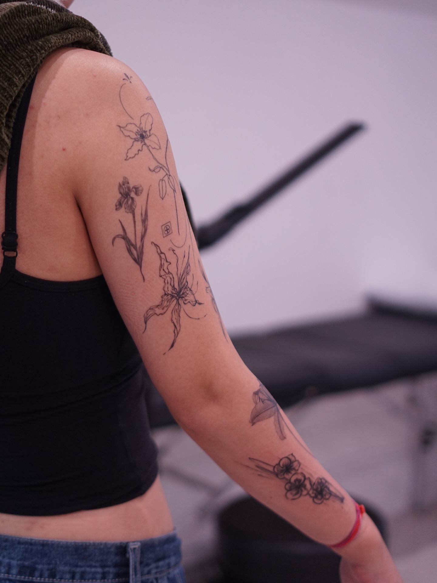 Floral arrangement black and grey tattoo on the forearm by Young one 영원