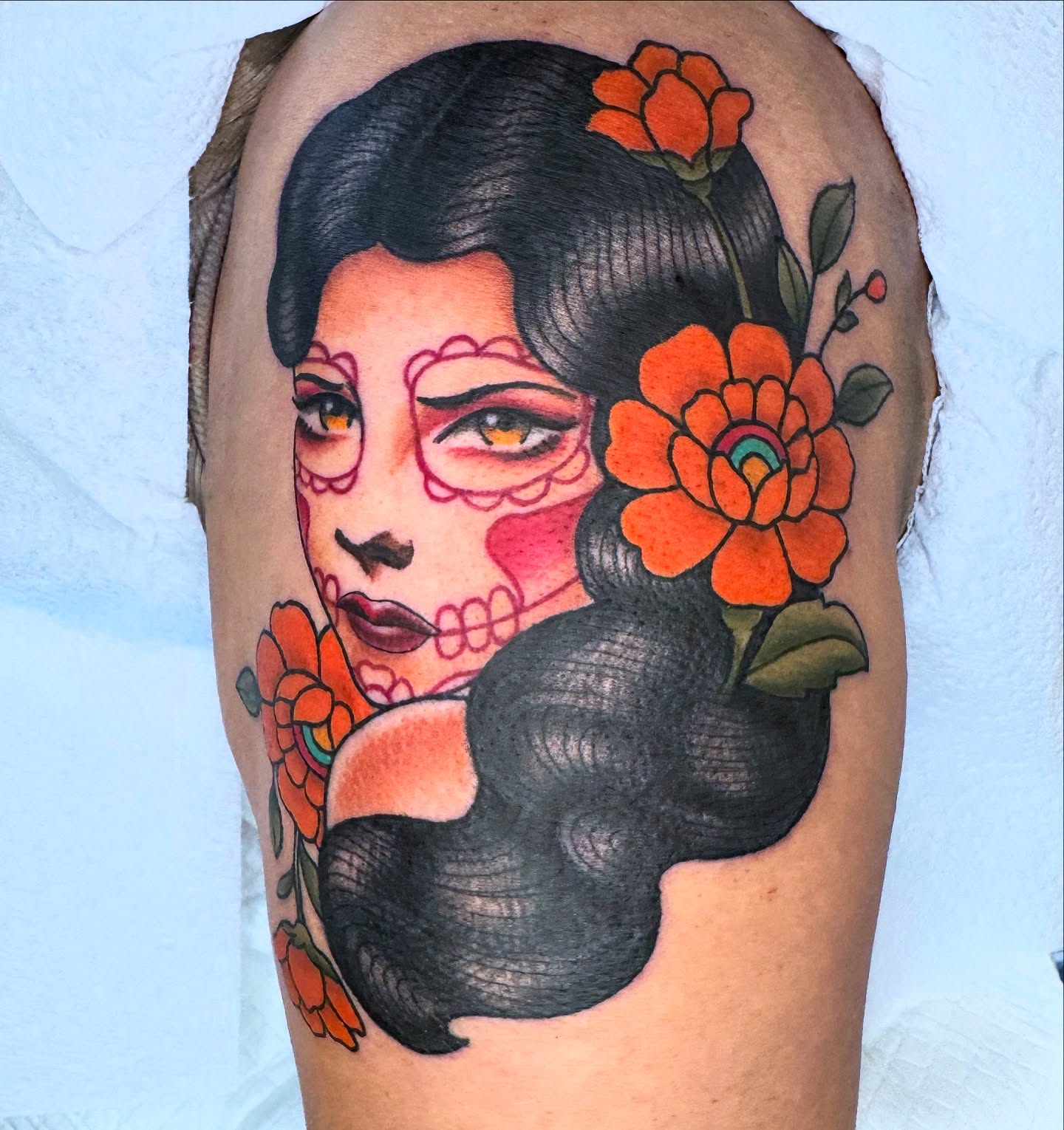 Woman with sugar skull makeup American traditional tattoo on the thigh by Lisa Del Toro