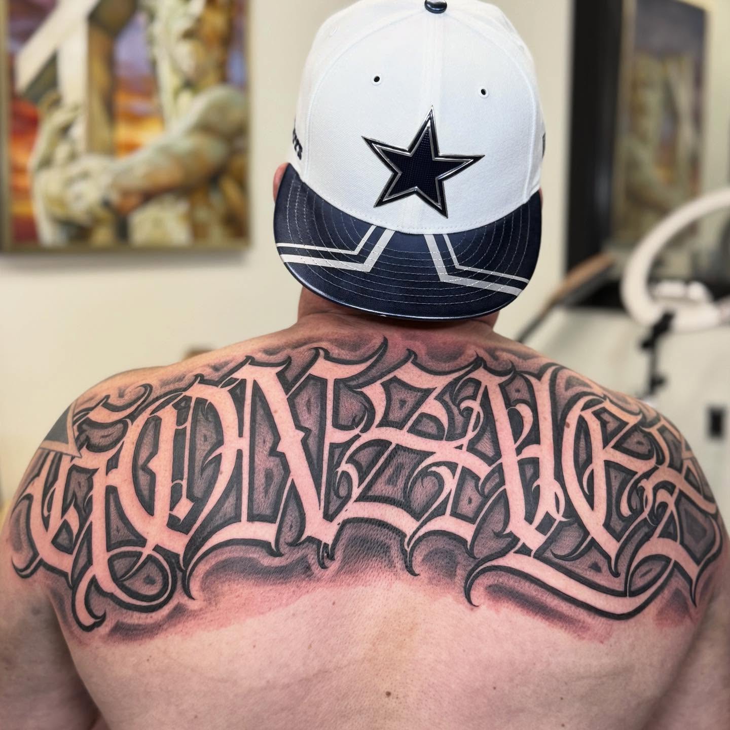 Gothic script black and grey tattoo on the back by @nickysix86