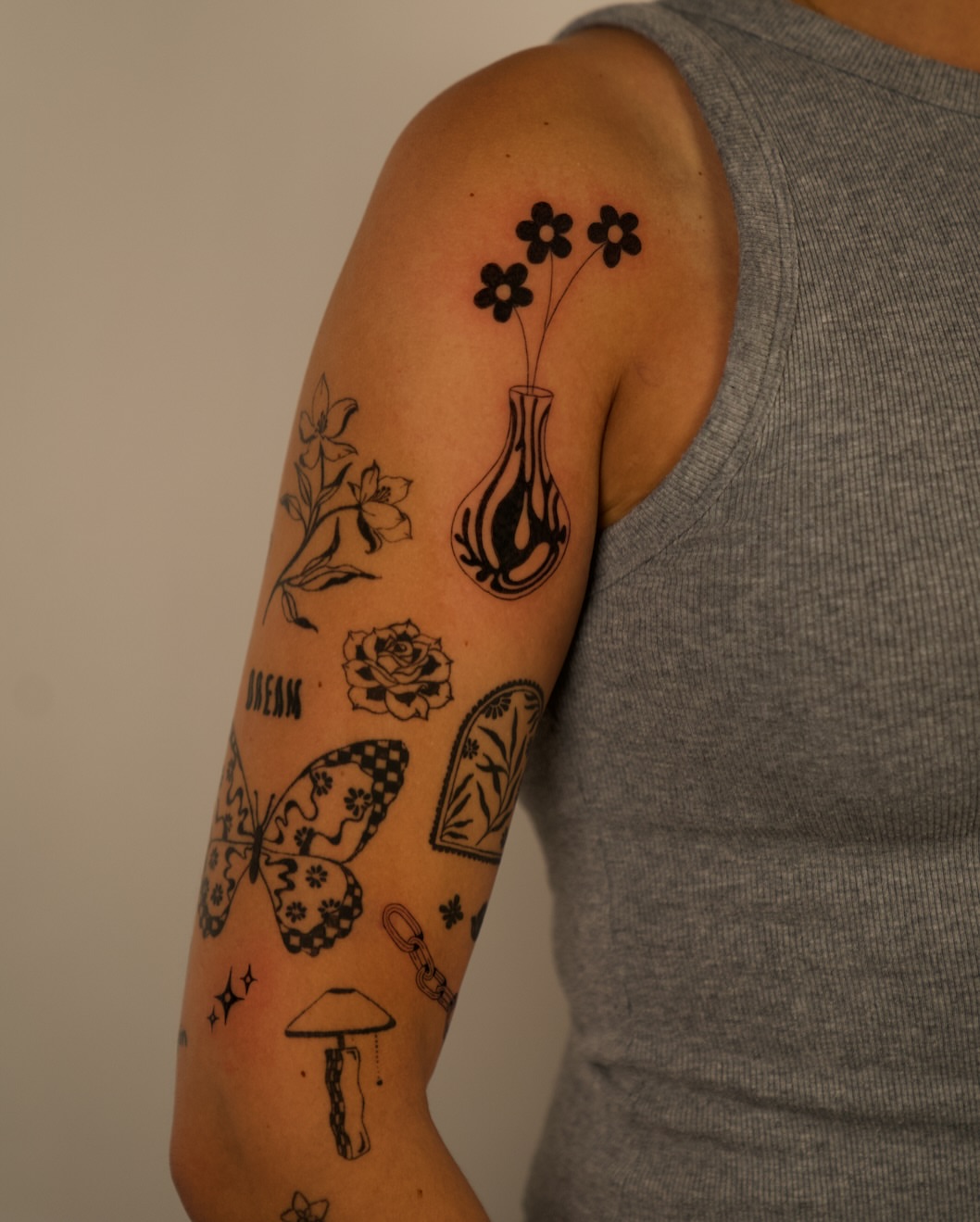 Flowers and vase black and grey tattoo on the forearm by b i l l i e, Seattle, Washington