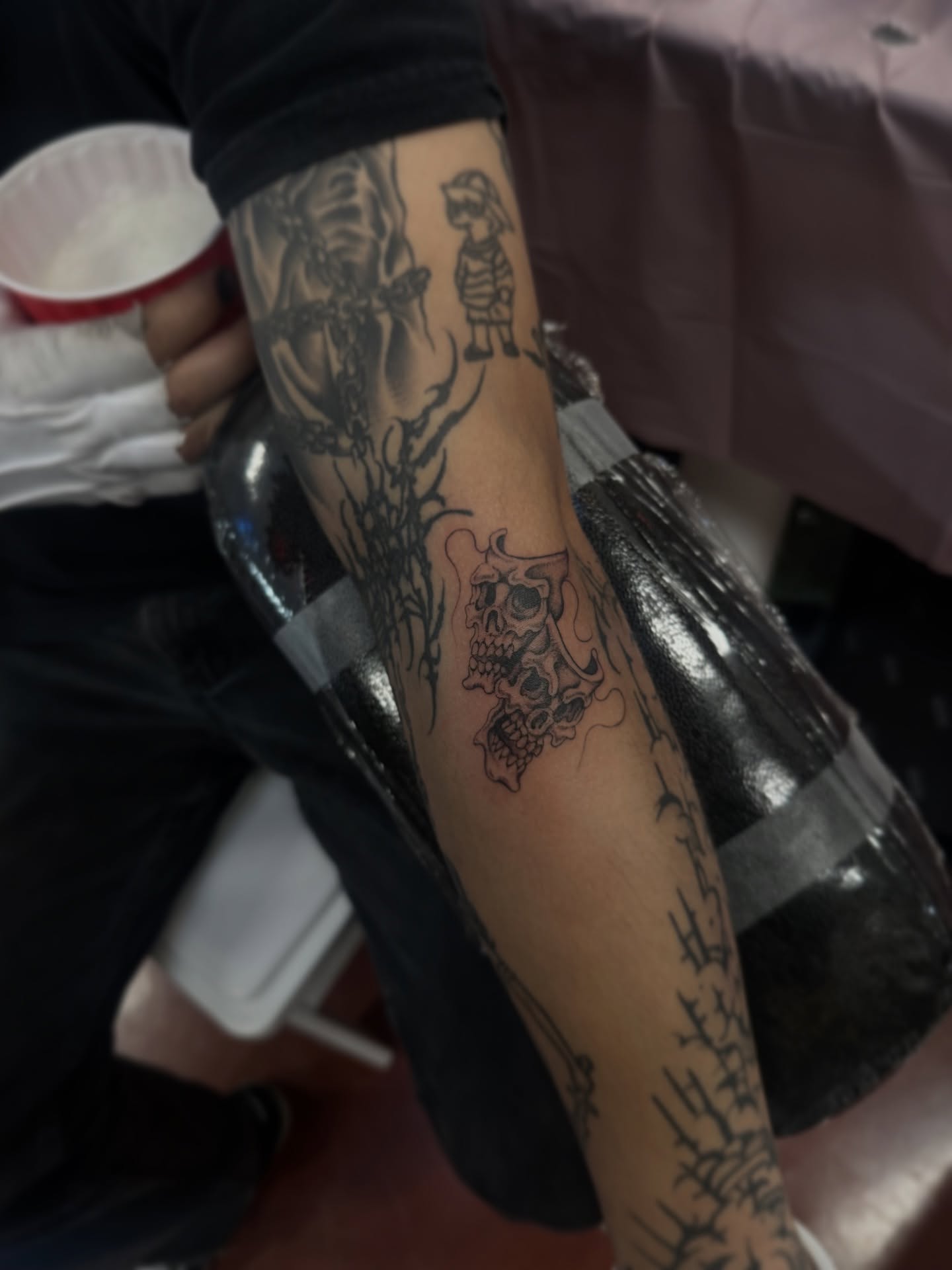 Skulls and flames black and grey tattoo on the forearm by Адріянна Стабс 🇺🇦, New York, New York