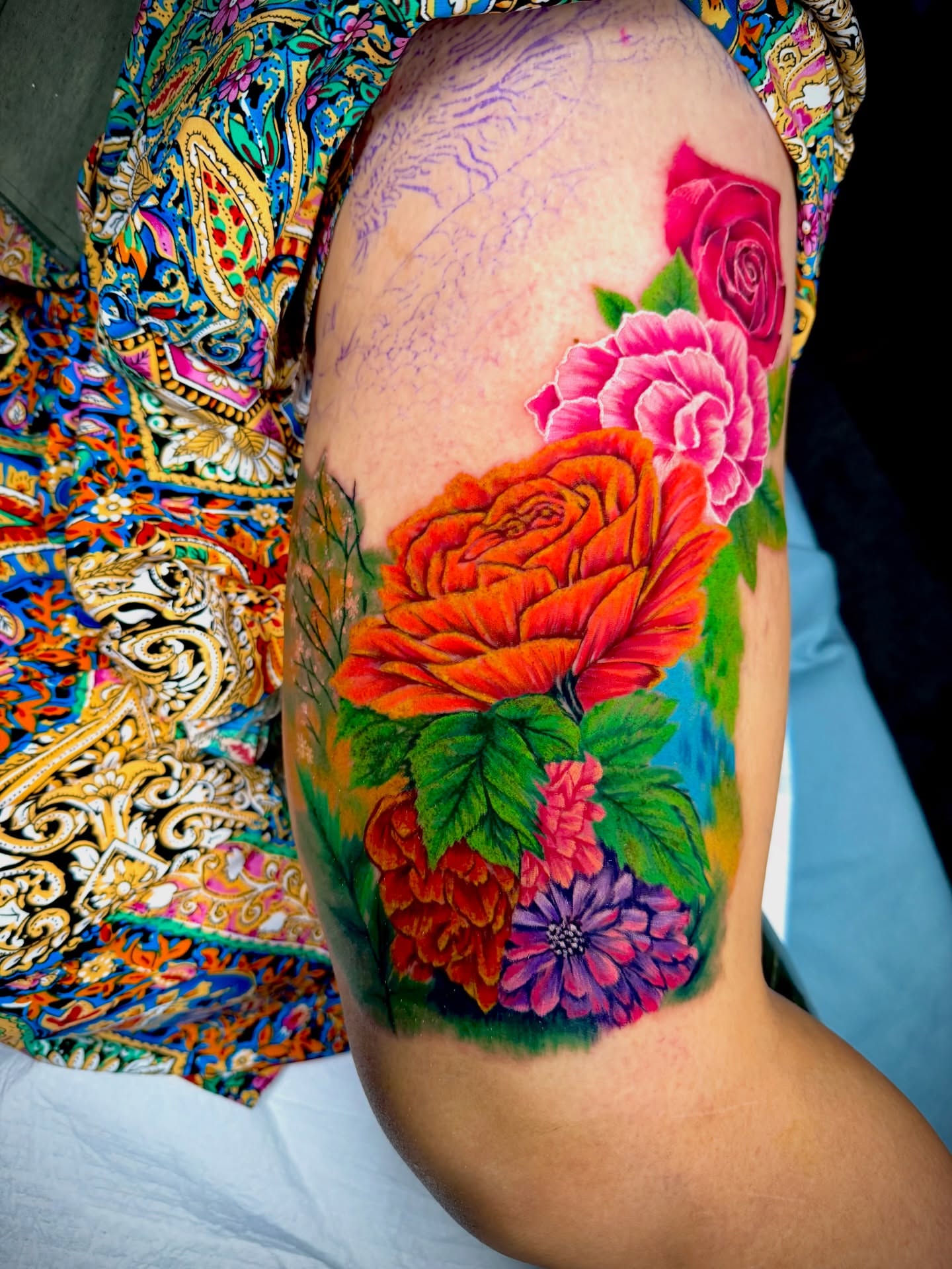 Floral bouquet realism tattoo on the upper arm by John Ayson, Murrieta, California