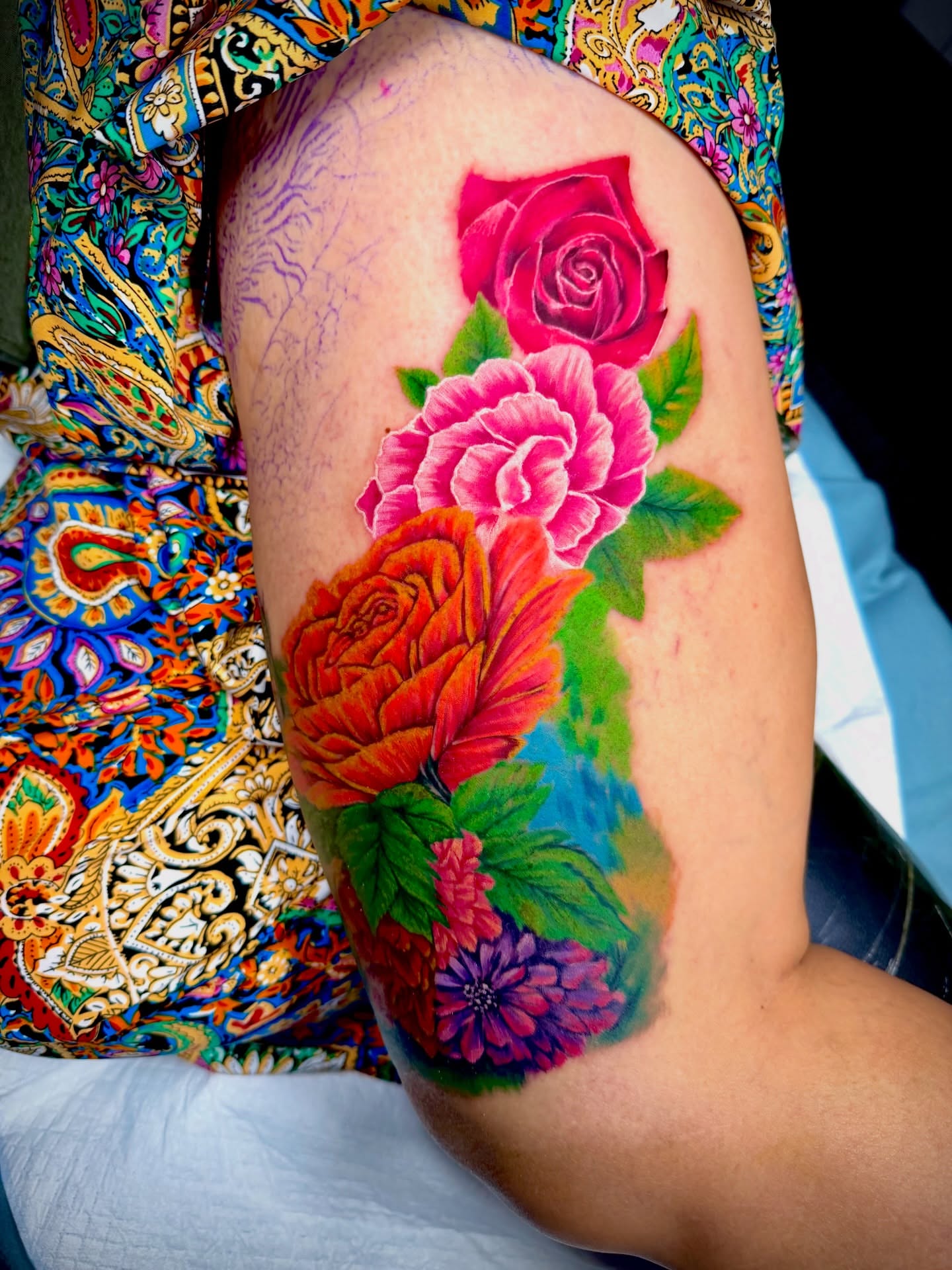 Flowers realism tattoo on the thigh by John Ayson, Murrieta, California