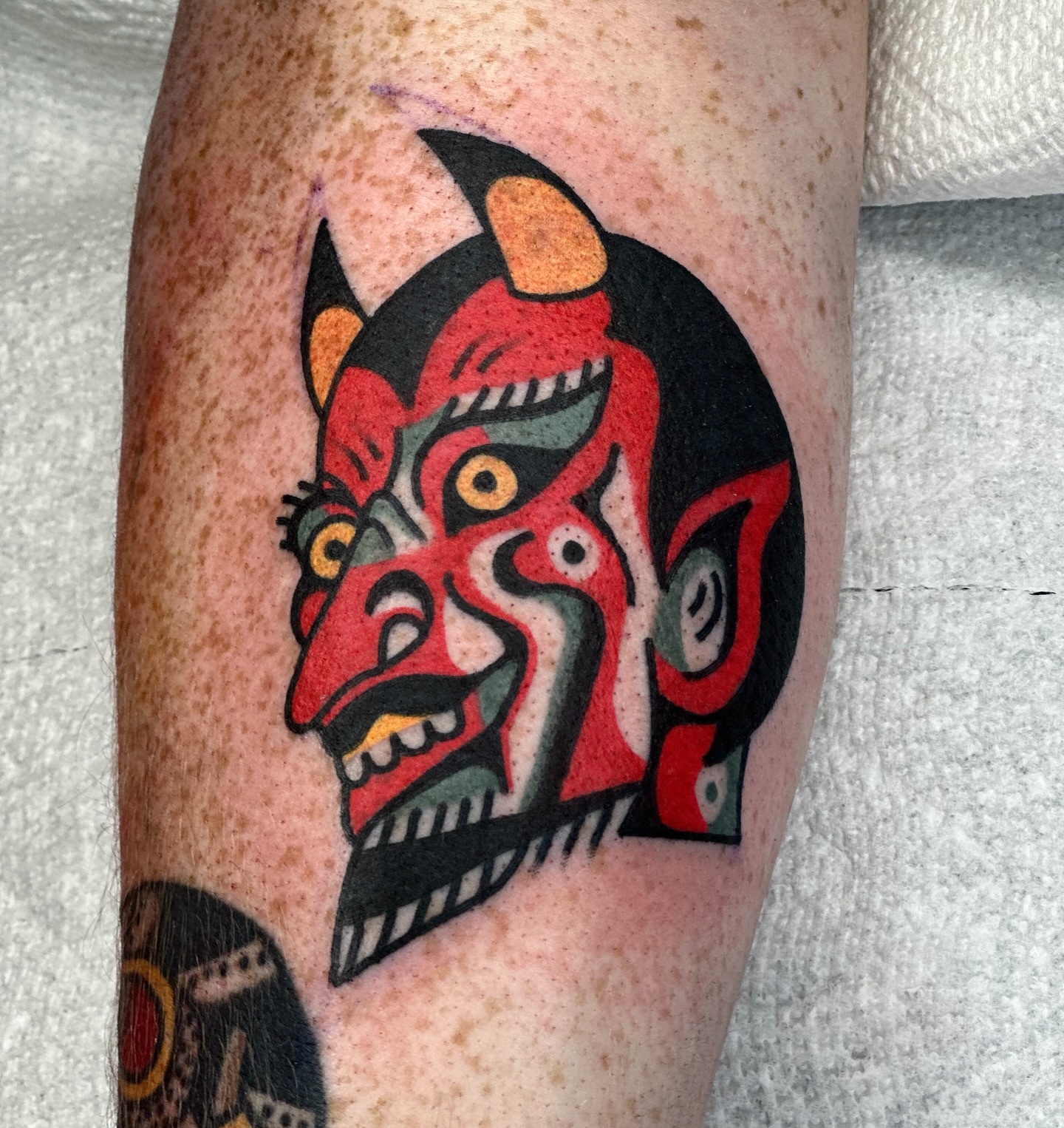 Demon mask American traditional tattoo on the forearm by Maks