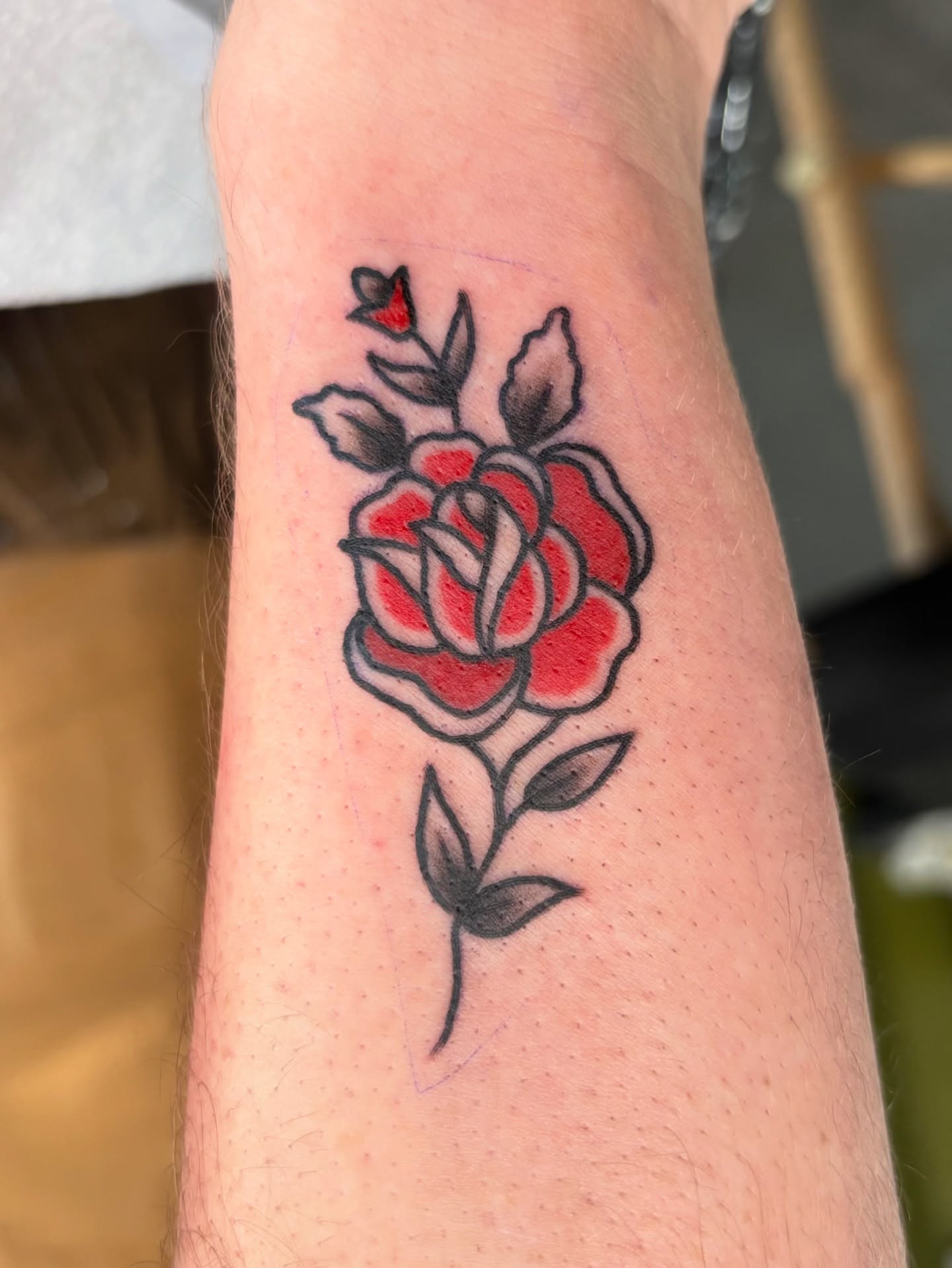 Red rose American traditional tattoo on the forearm by Jamie Yuu, Minneapolis, Minnesota