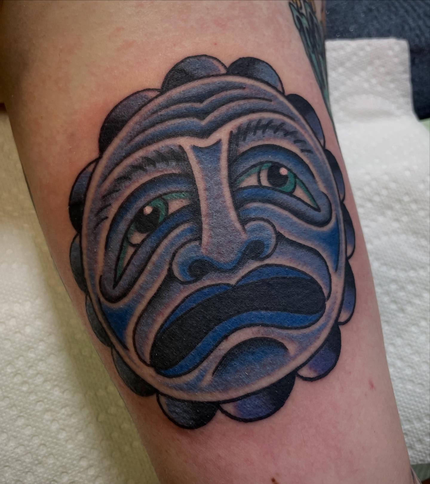 Sad mask American traditional tattoo on the forearm by Micheal McGlinchey
